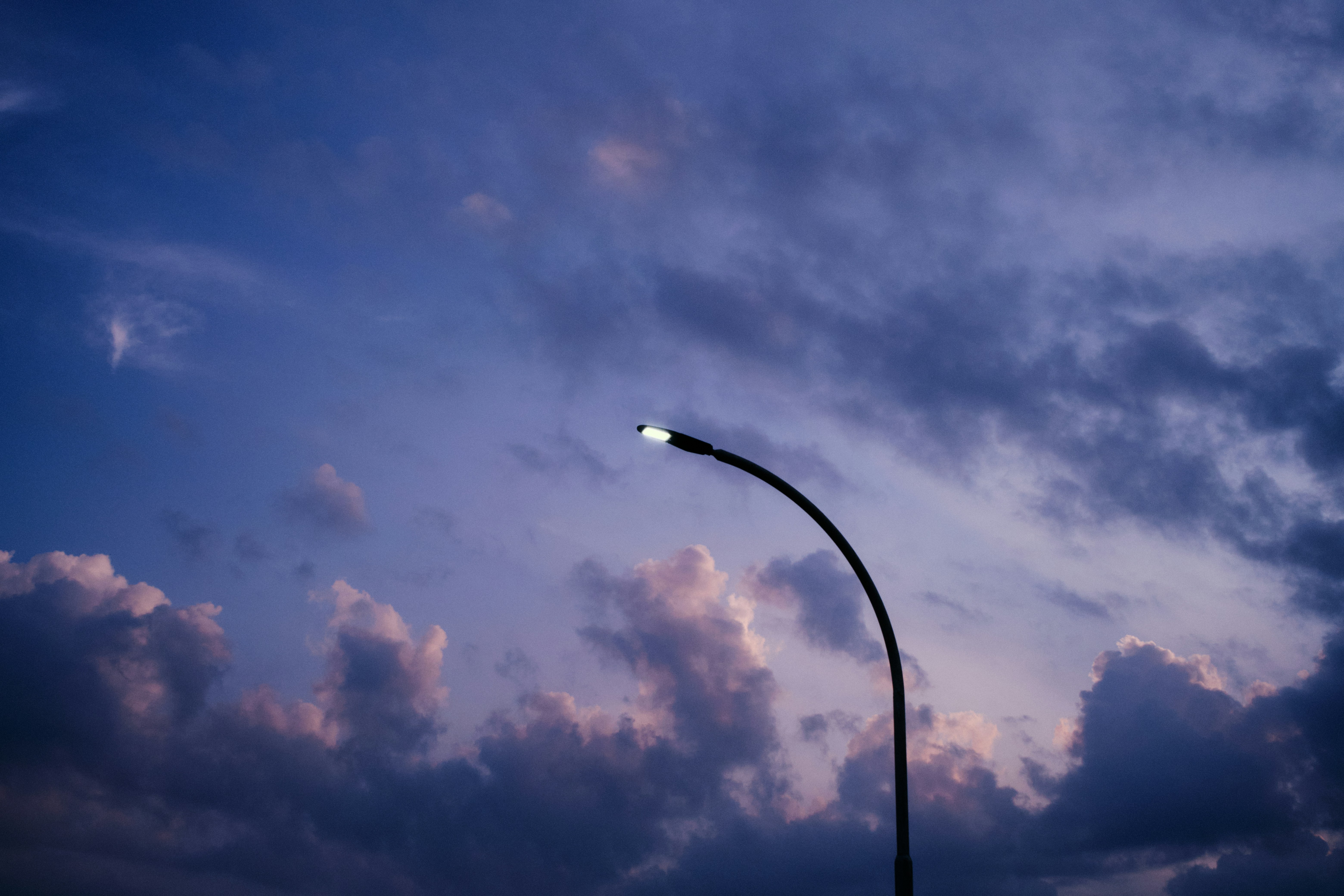 A lone streetlamp glows against a dusky sky.