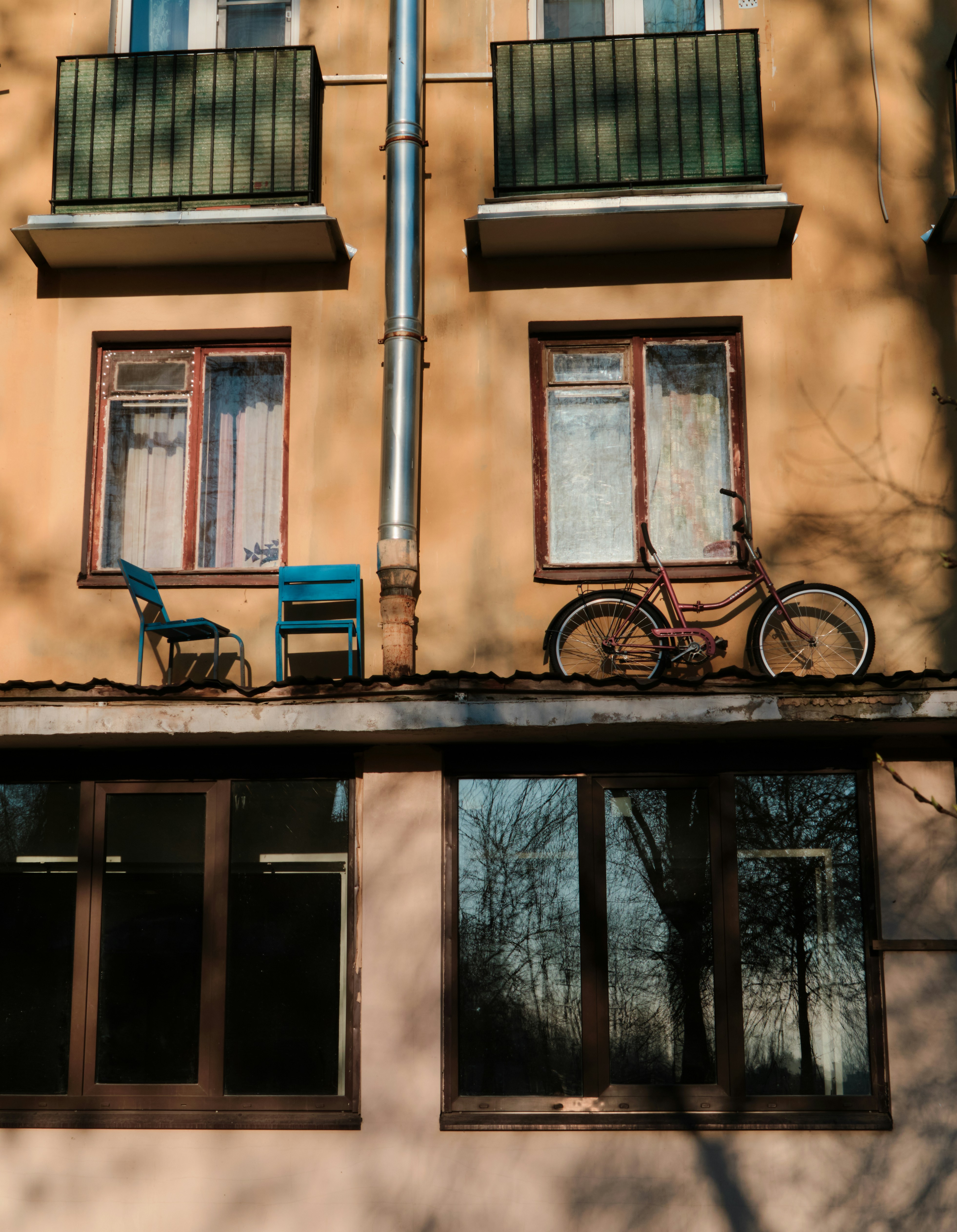 Old bicycle and chairs on building roof
