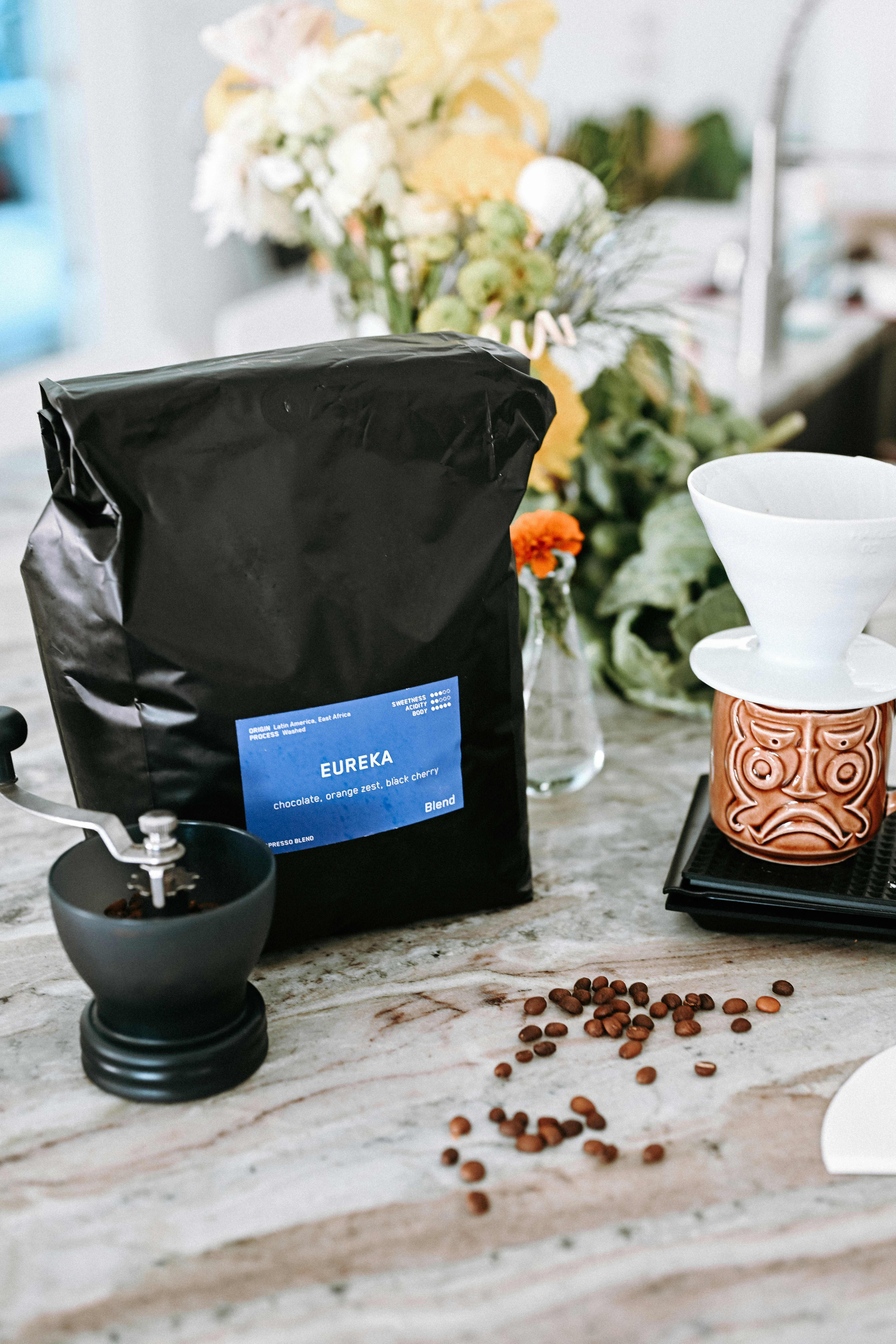 Coffee beans, grinder, and brewing equipment on counter