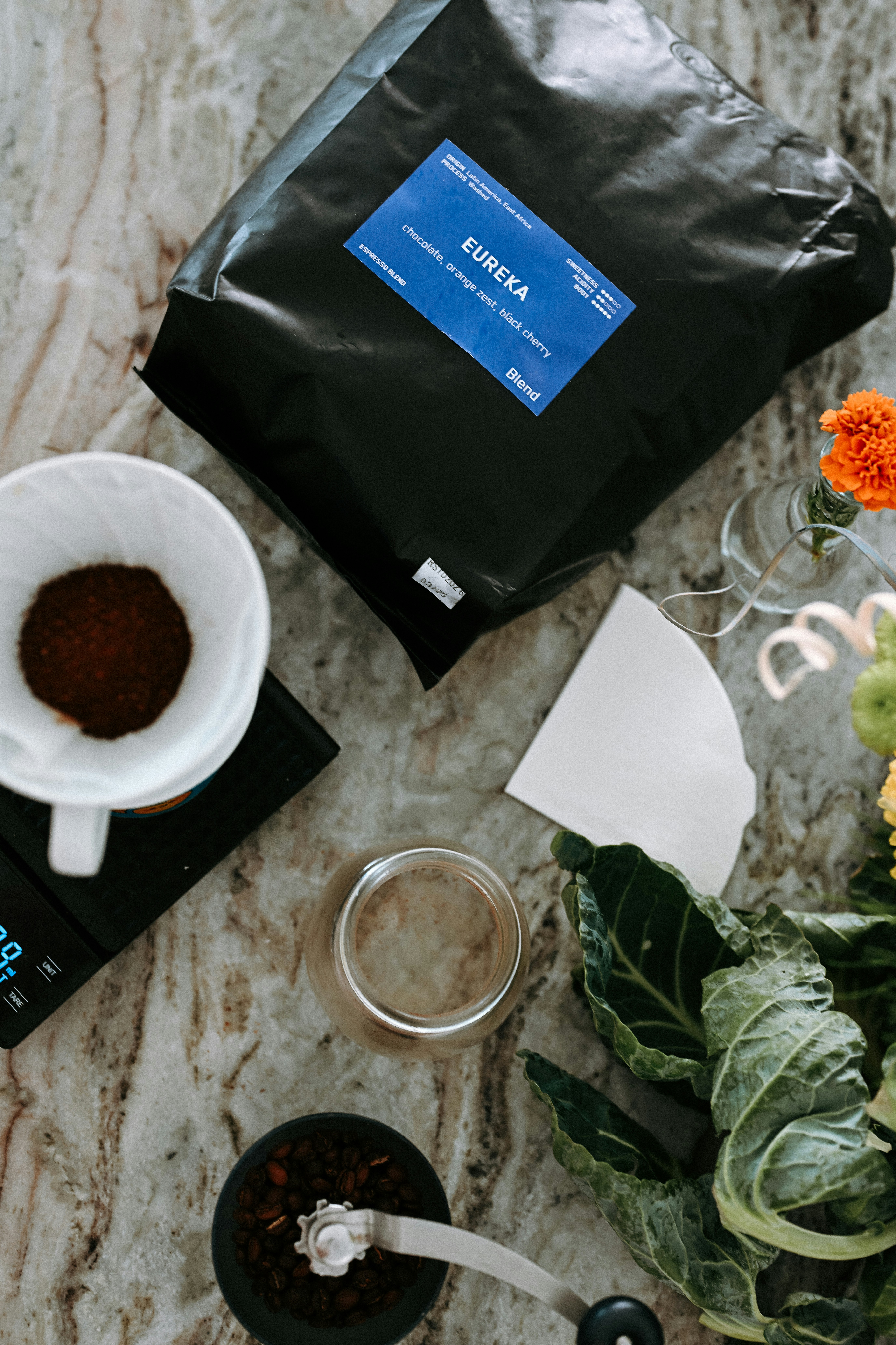 Coffee beans and brewing equipment on marble countertop