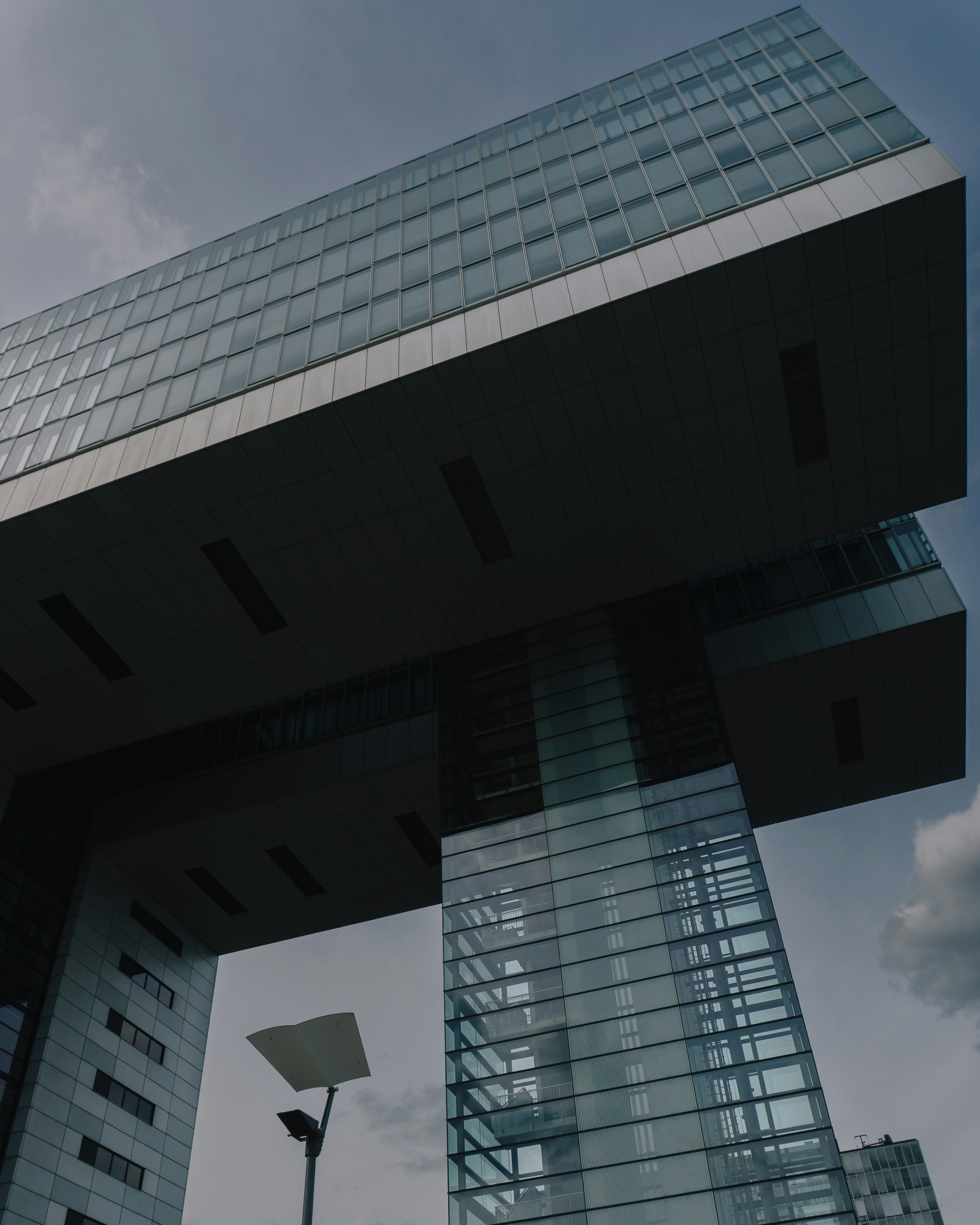 Modern glass buildings against a cloudy sky