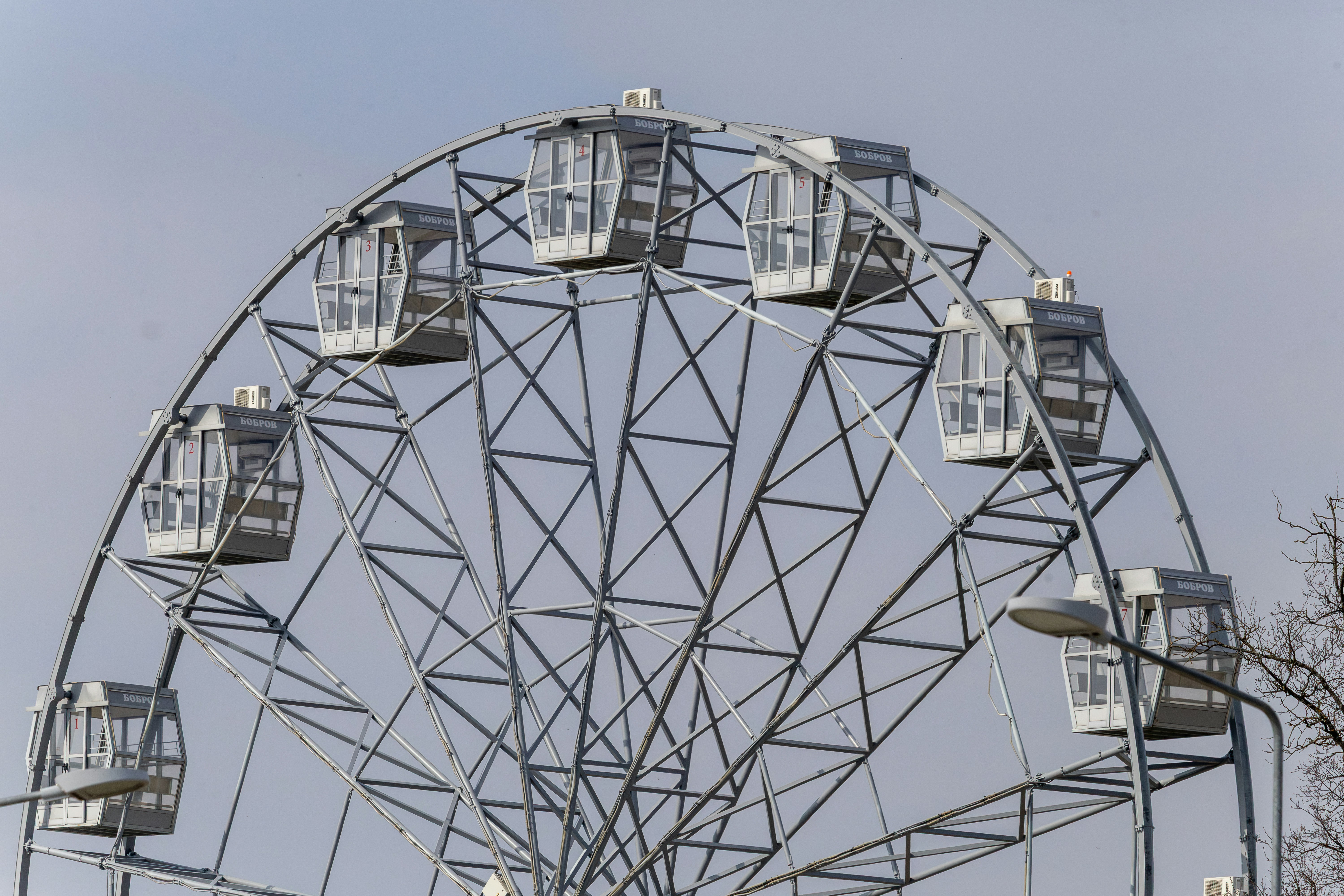 A white ferris wheel against a pale sky