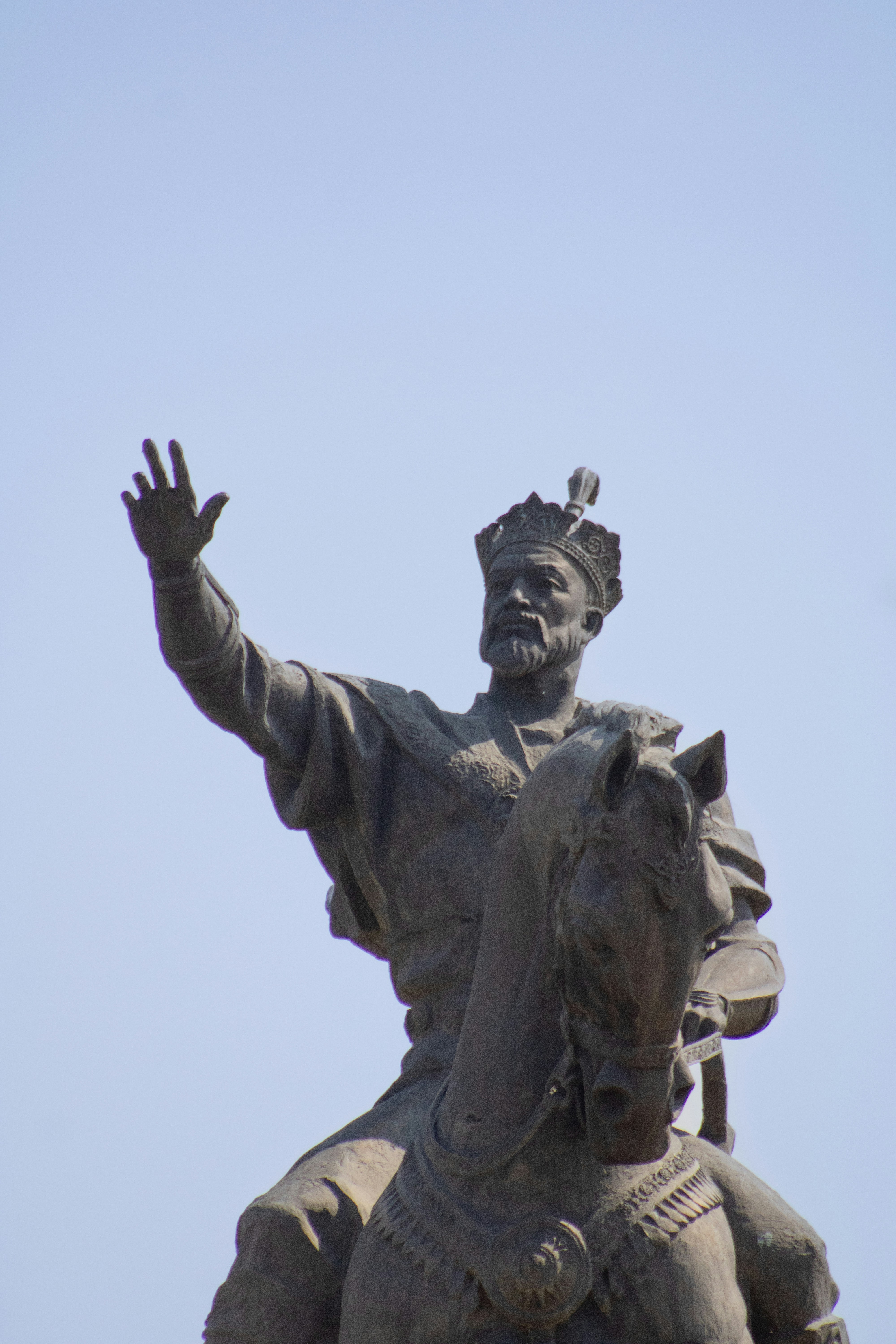 Statue of a king on horseback waving