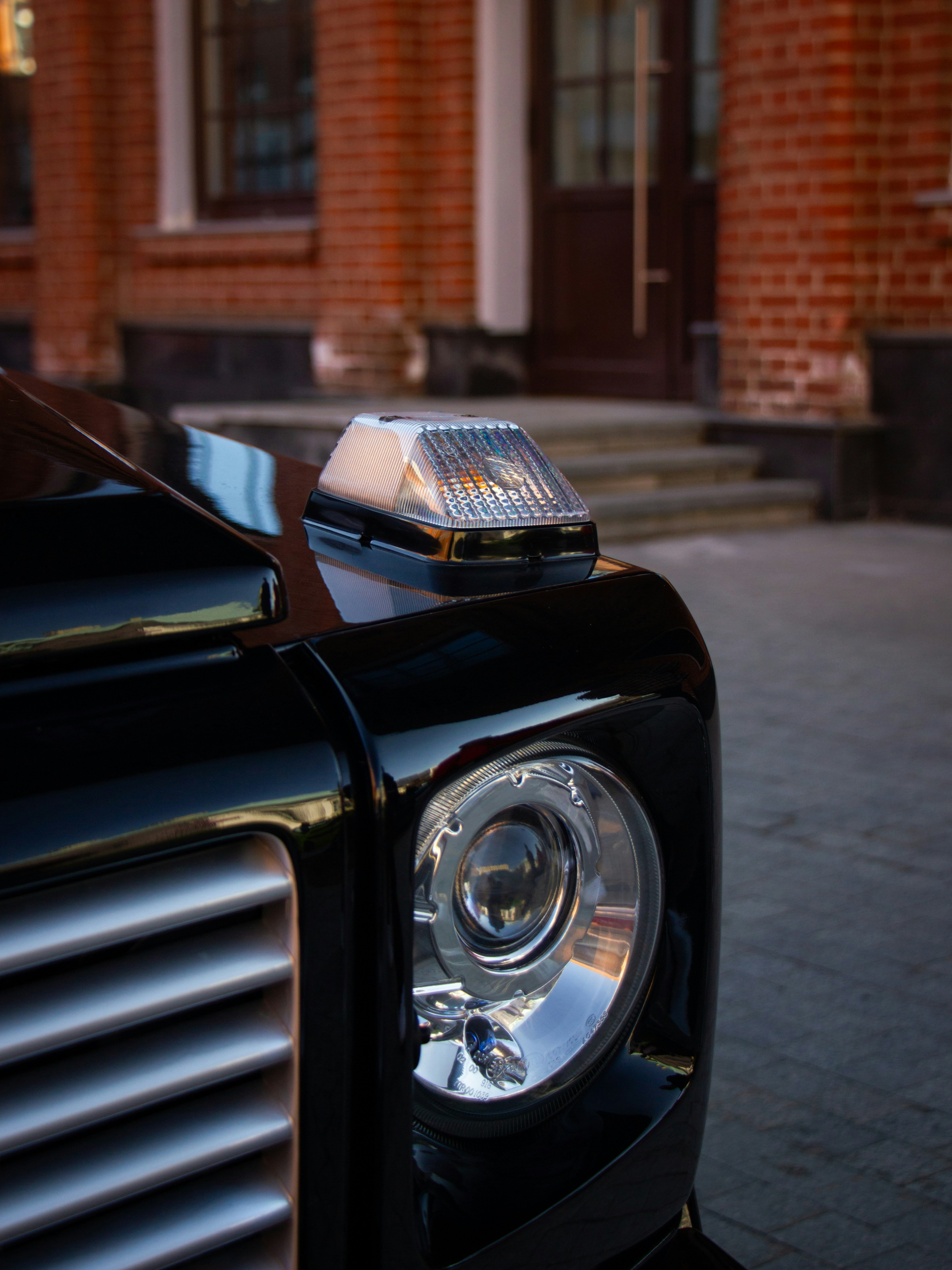 Close-up of a black luxury car headlight