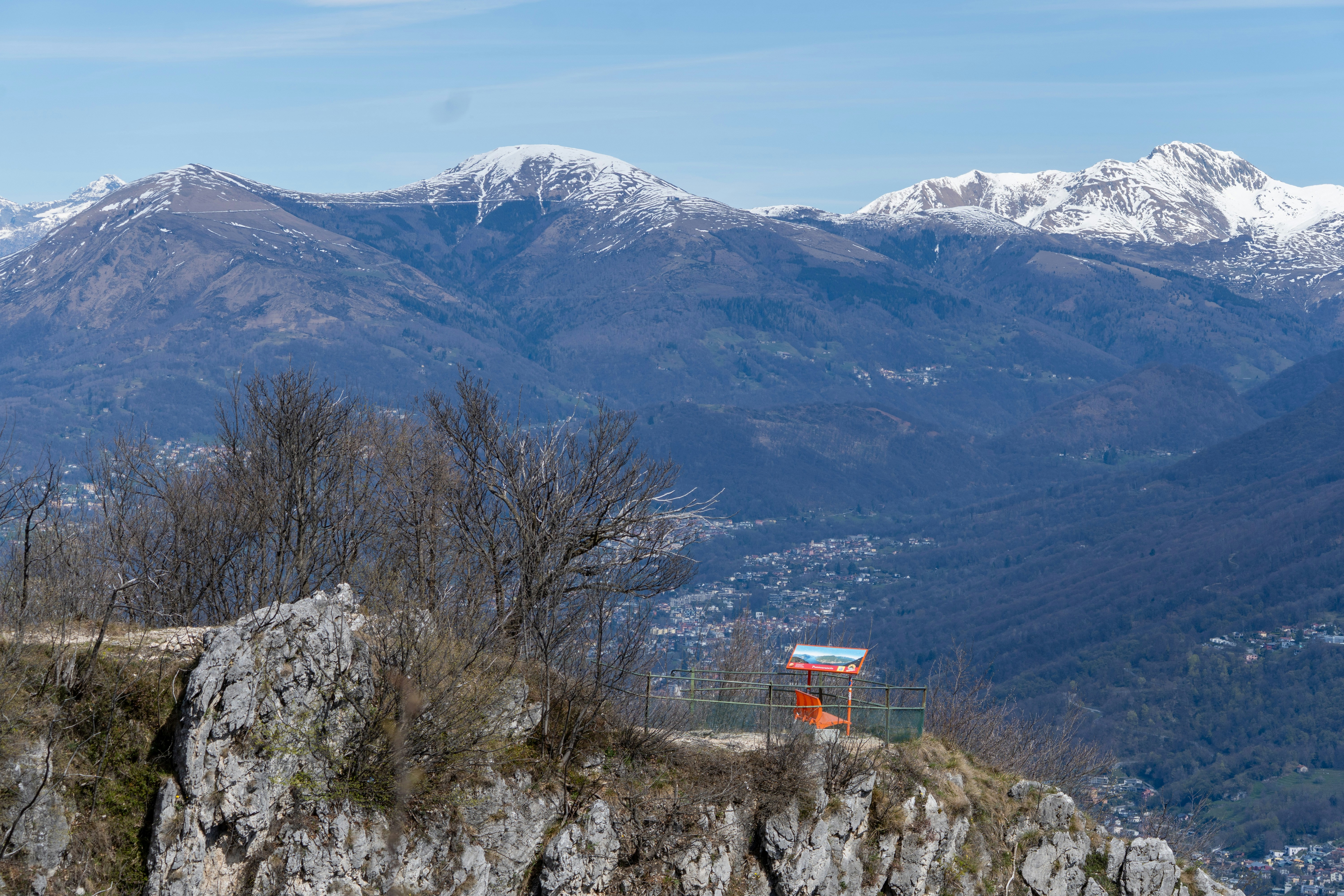 Snow-capped mountains overlook a valley with a small structure.