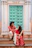 Couple in traditional indian attire sitting on steps.