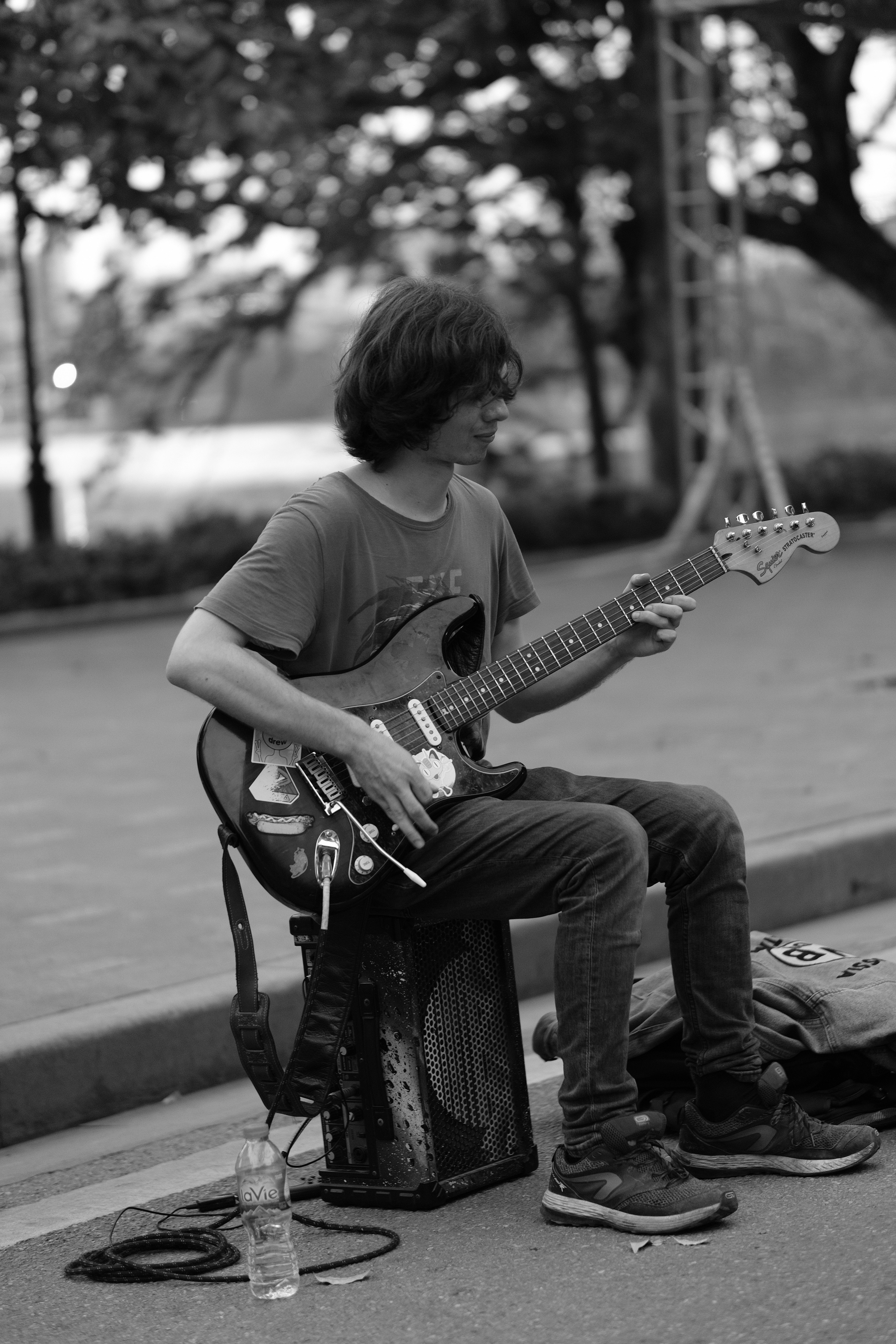 a street performer (guitarist) at hoan kiem lake, hanoi old town
