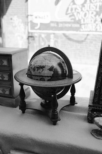 An antique globe on a wooden stand.