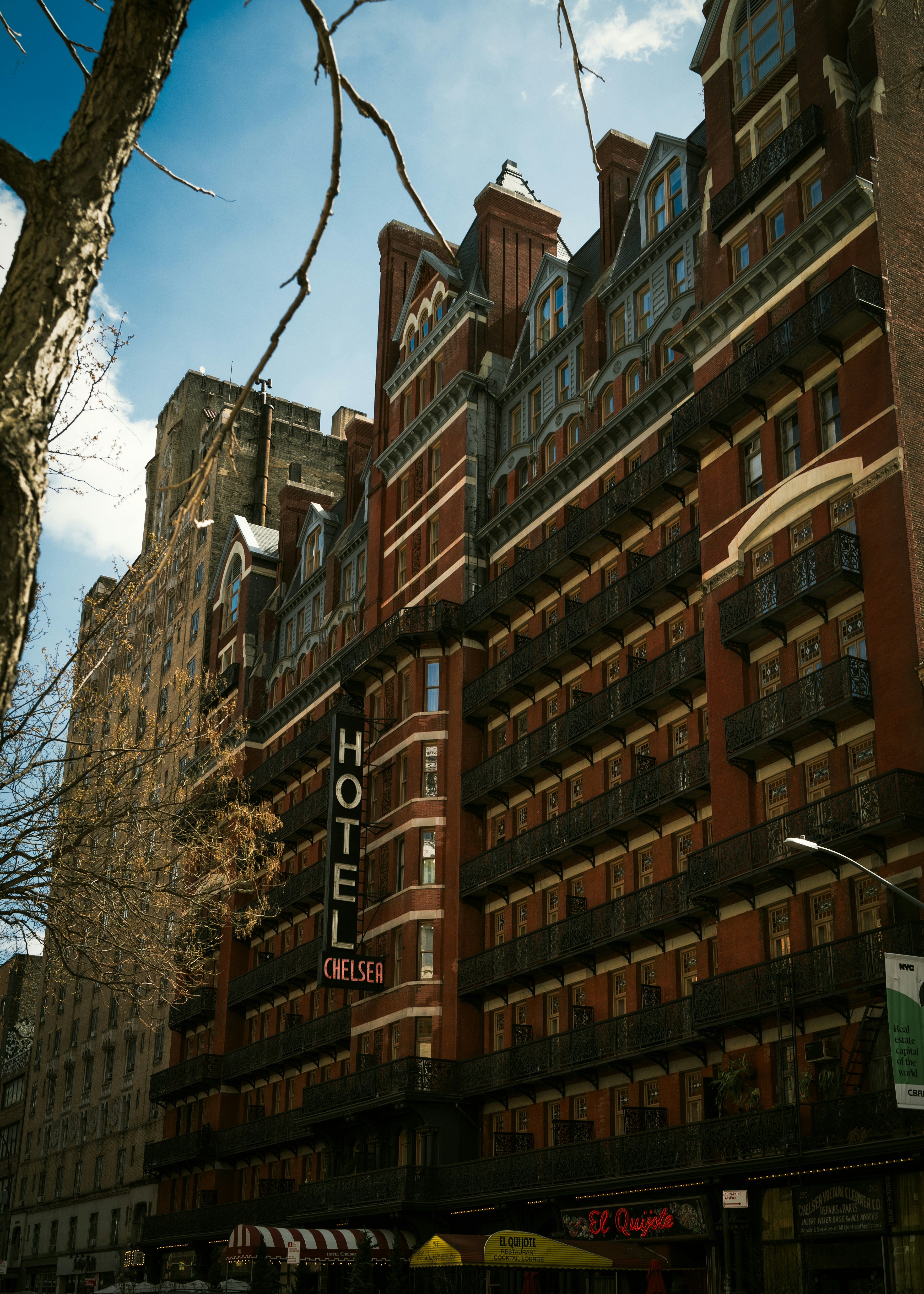 Brick hotel building with balconies and sign