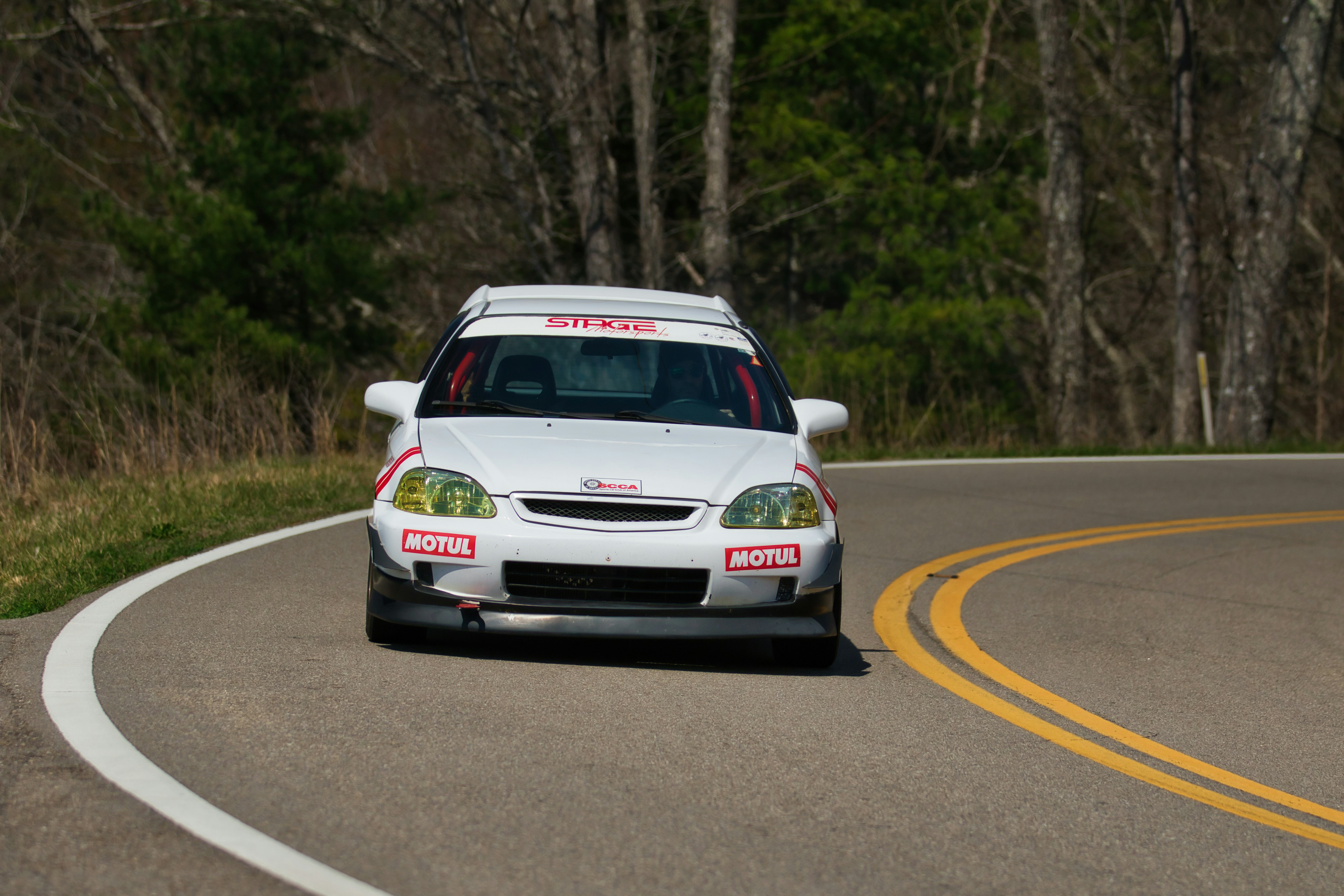 White race car driving on a winding road photo – Free Sports car Image ...