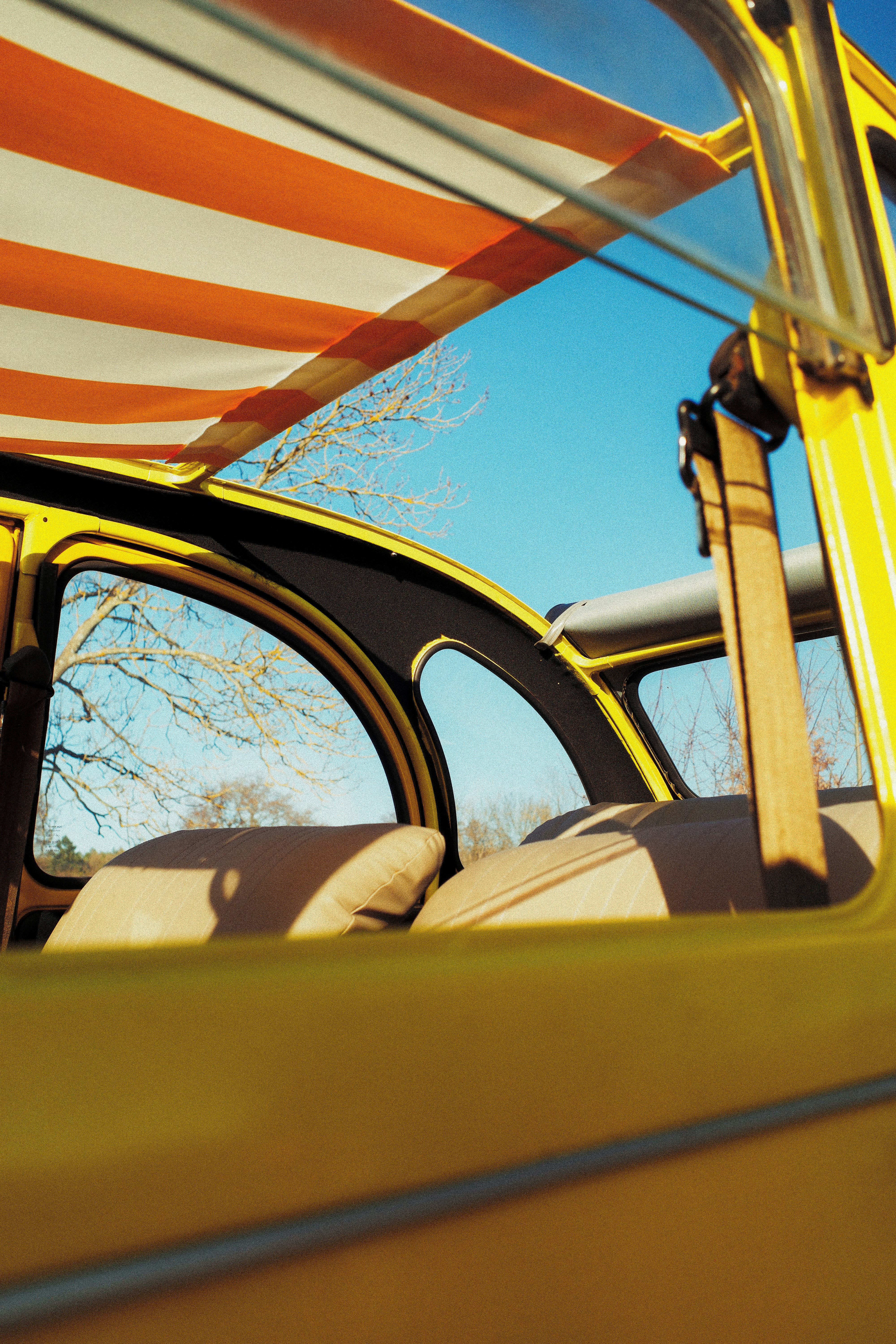 Yellow vintage car interior with striped awning