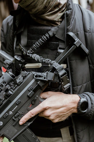 Man in tactical gear holding a rifle