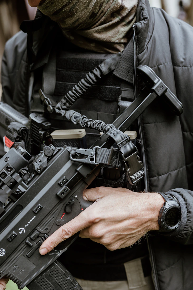 Man in tactical gear holding a rifle