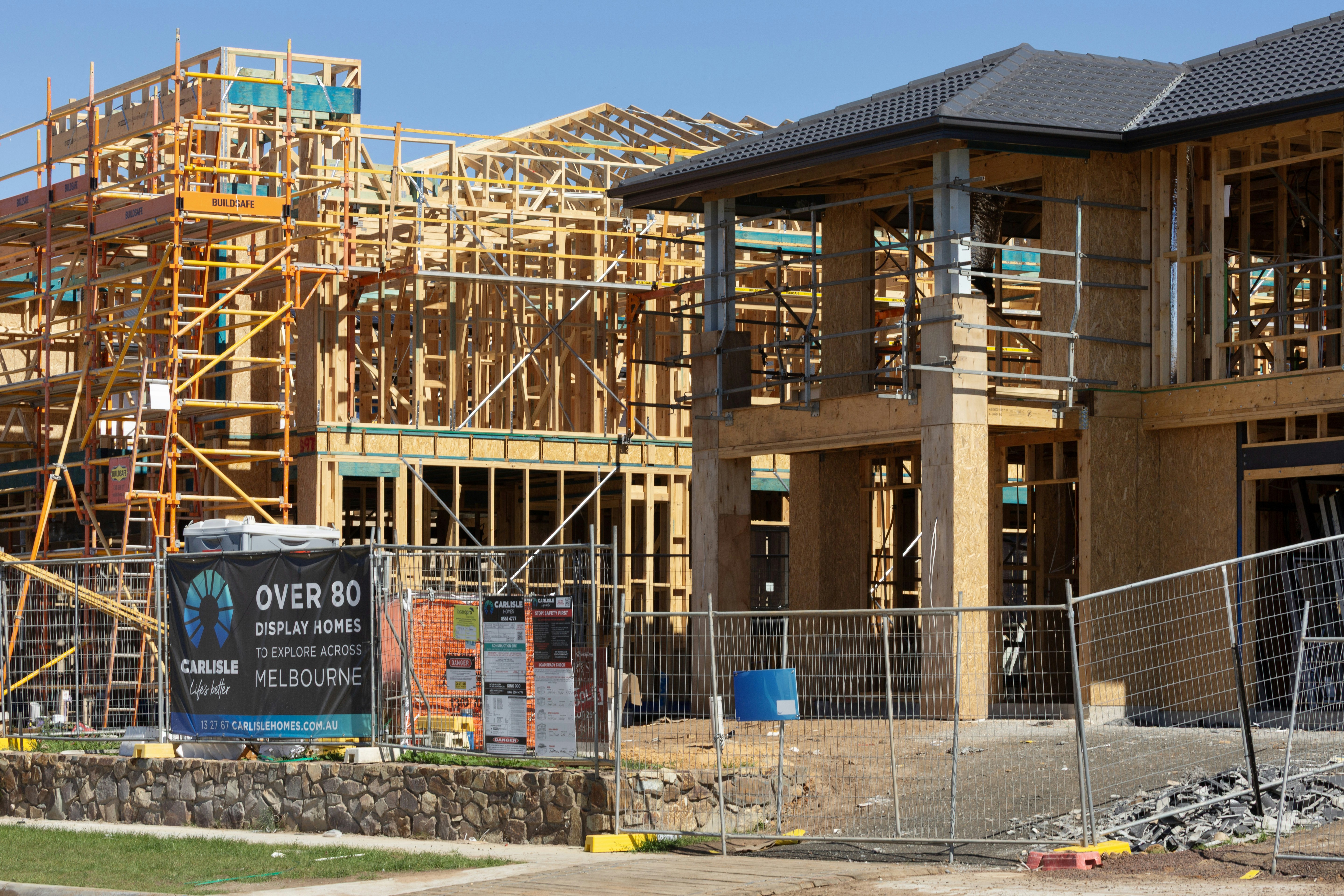 New houses under construction with wooden framing.