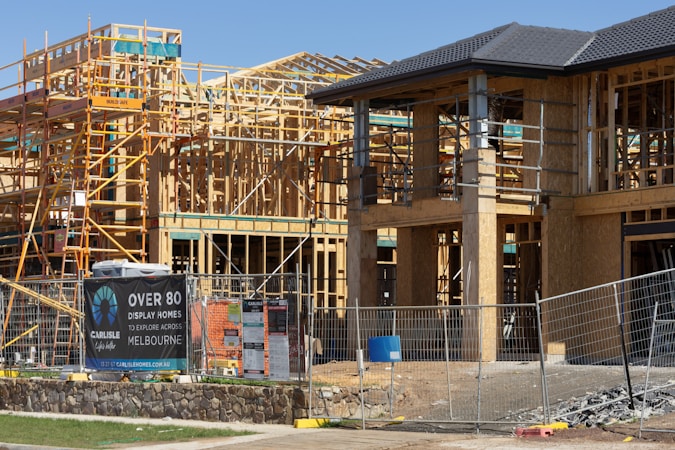 New houses under construction with wooden framing in a growing residential subdivision