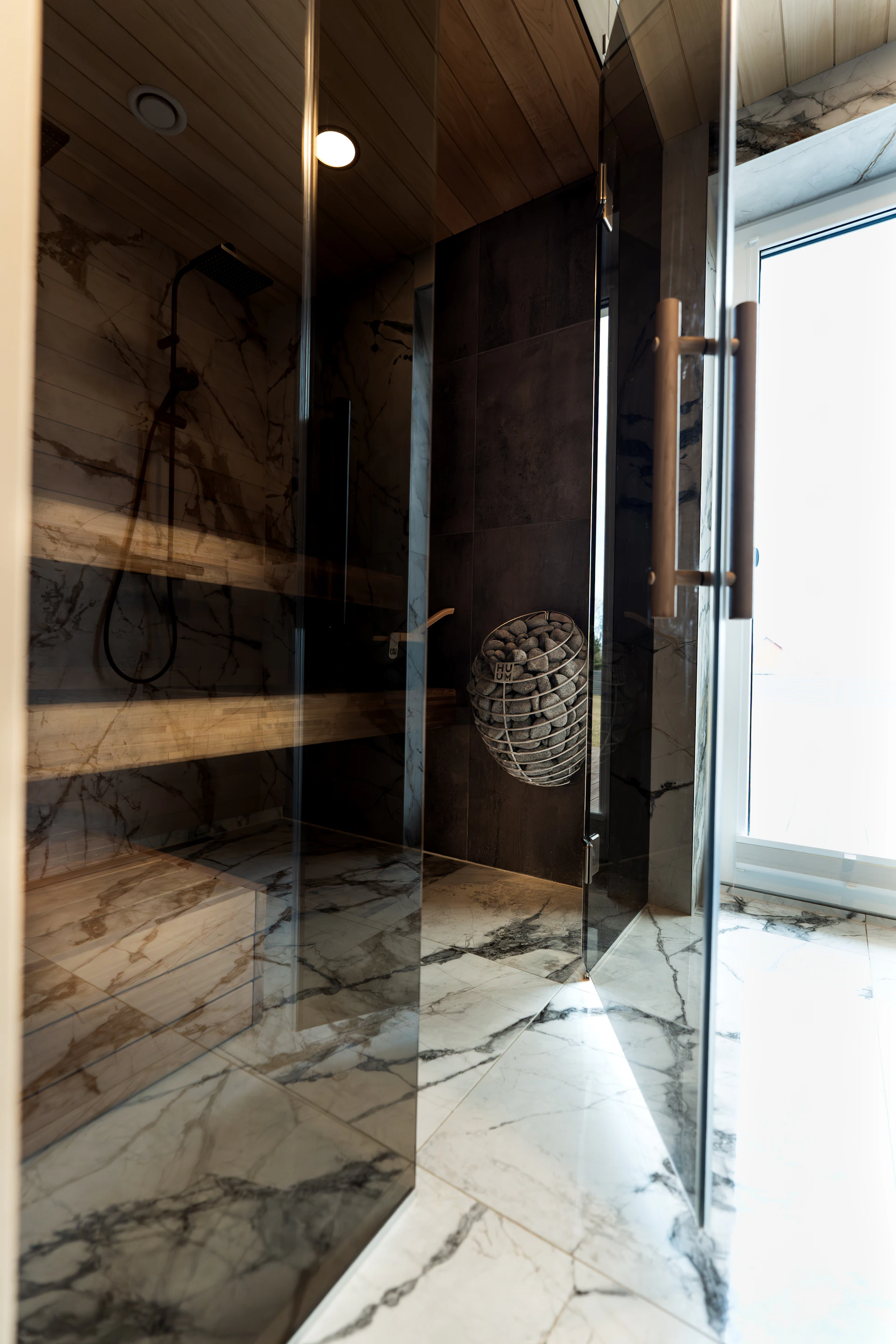 Modern bathroom with marble shower and wooden ceiling