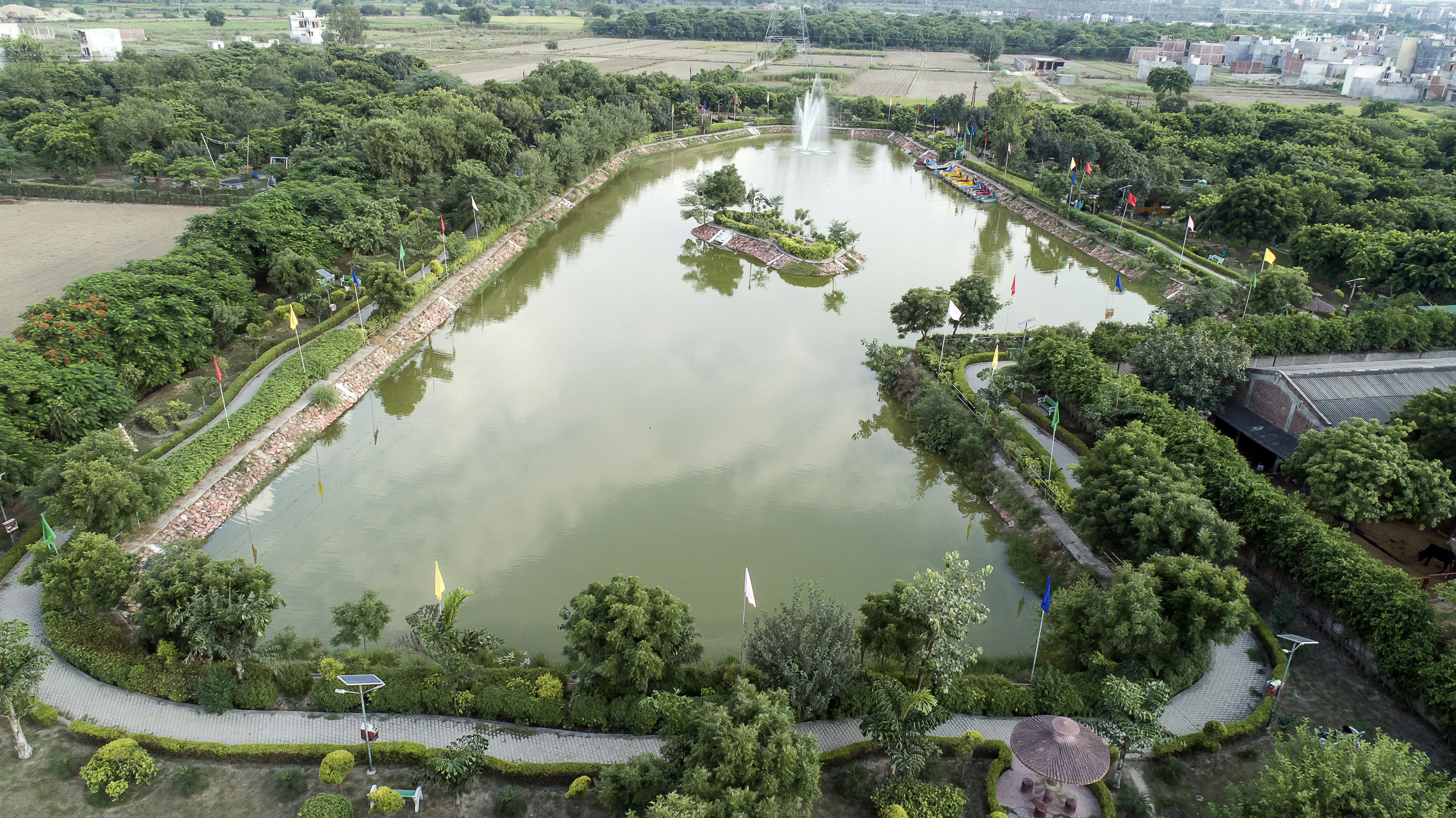 A scenic park with a large pond surrounded by trees