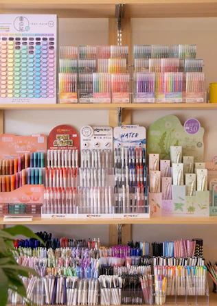 Colorful pens and art supplies displayed on shelves.