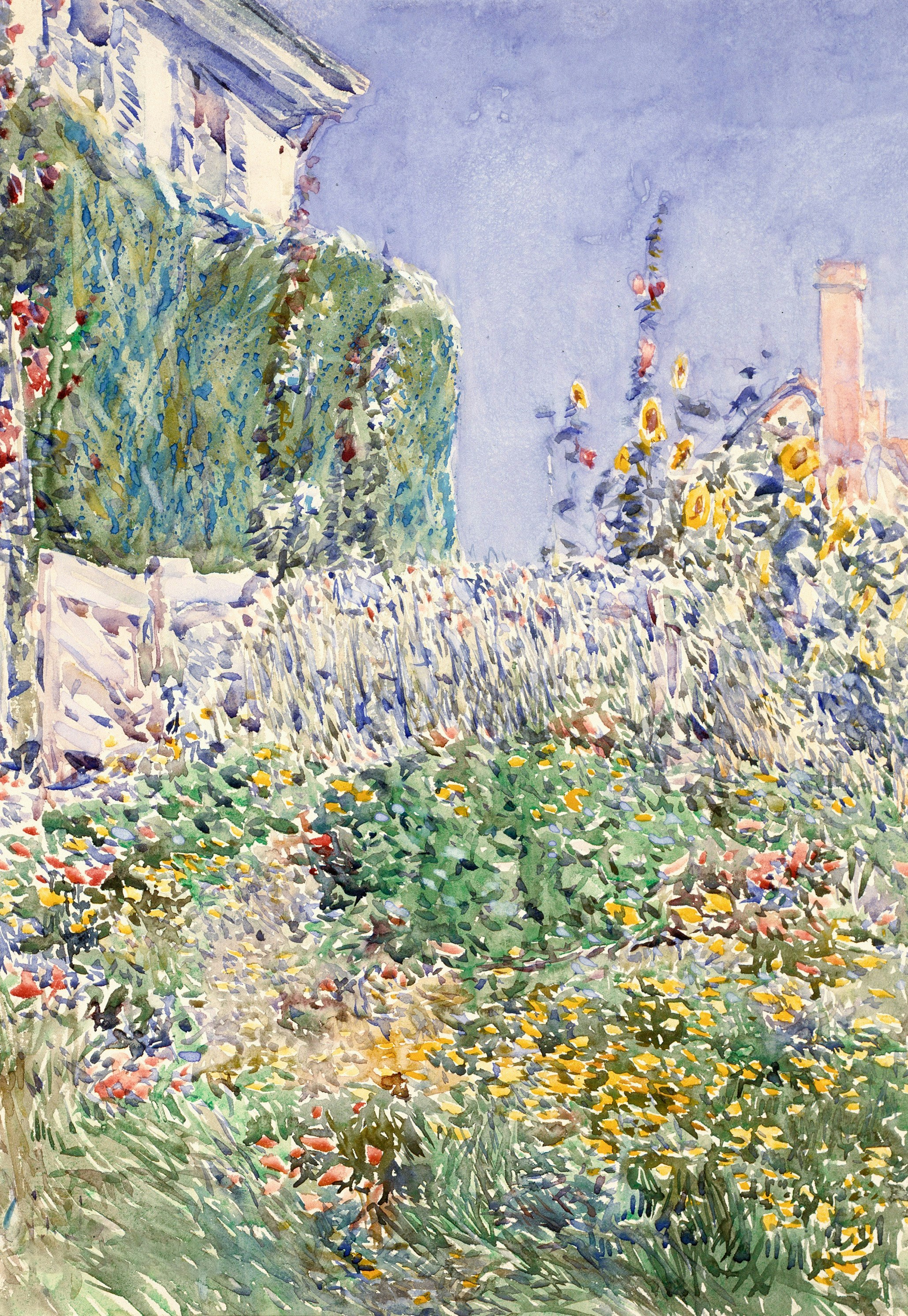A vibrant garden with a white fence and sunflowers