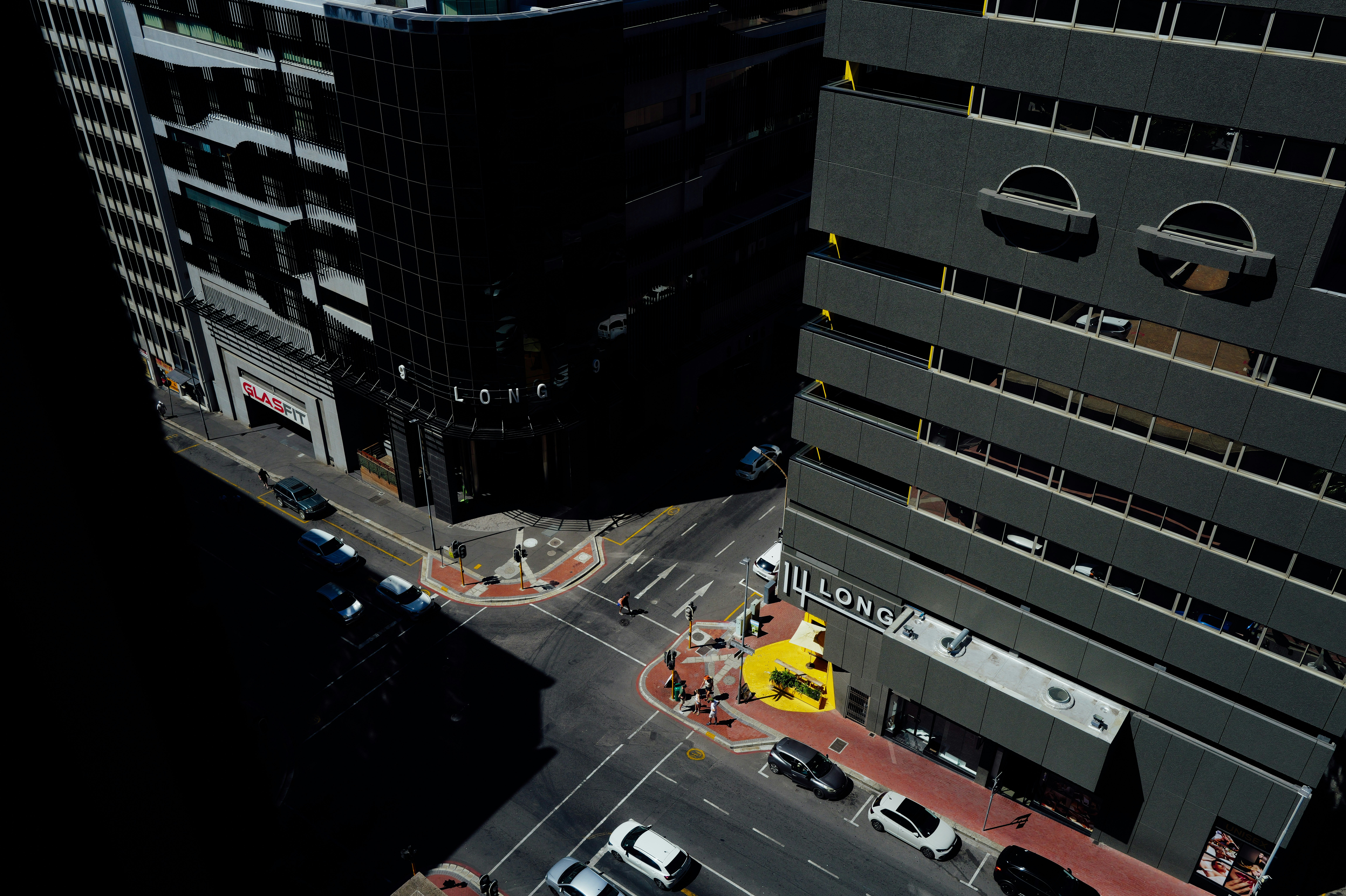 Aerial view of a city street intersection with buildings.