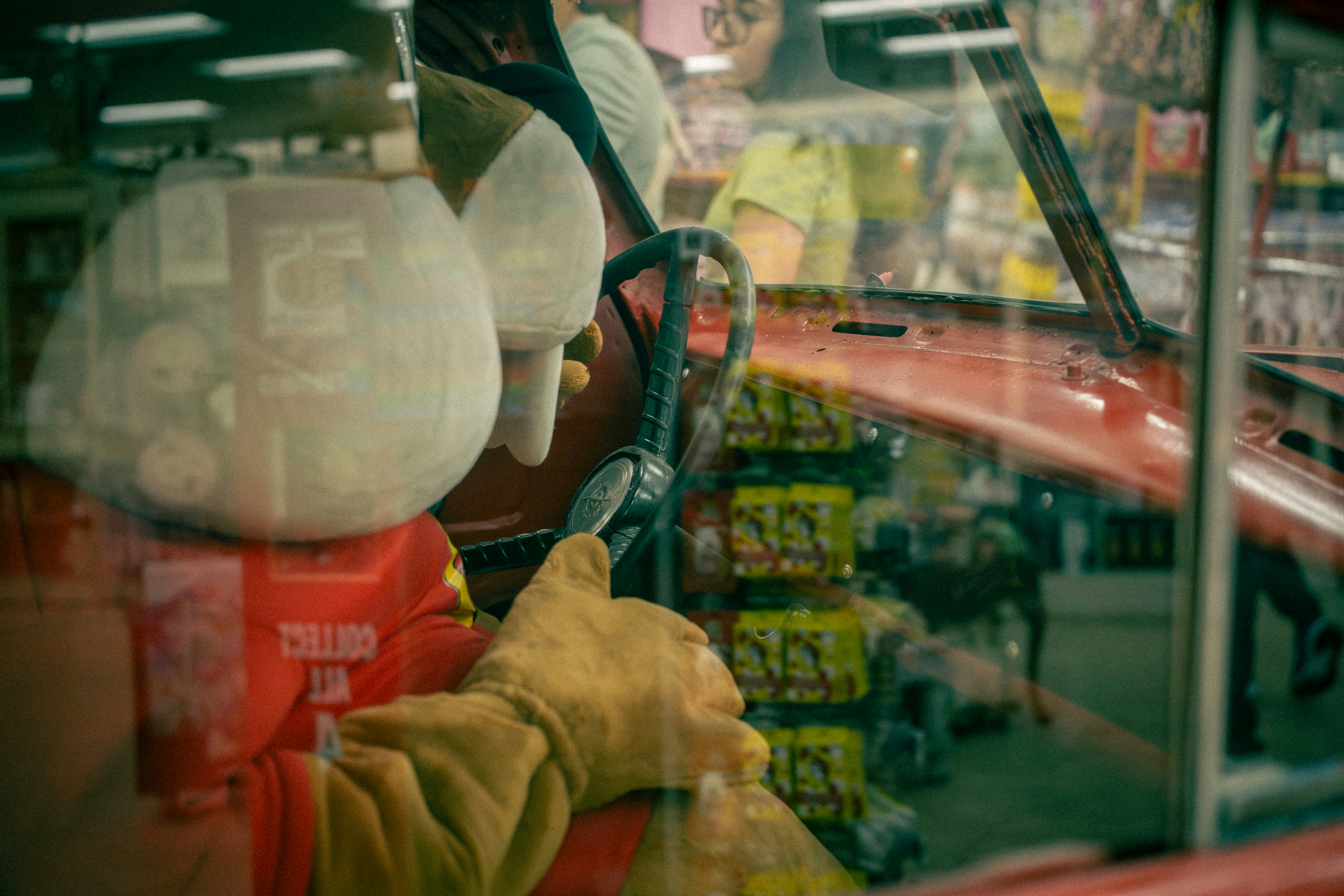 Person in red shirt and yellow gloves pumping gas