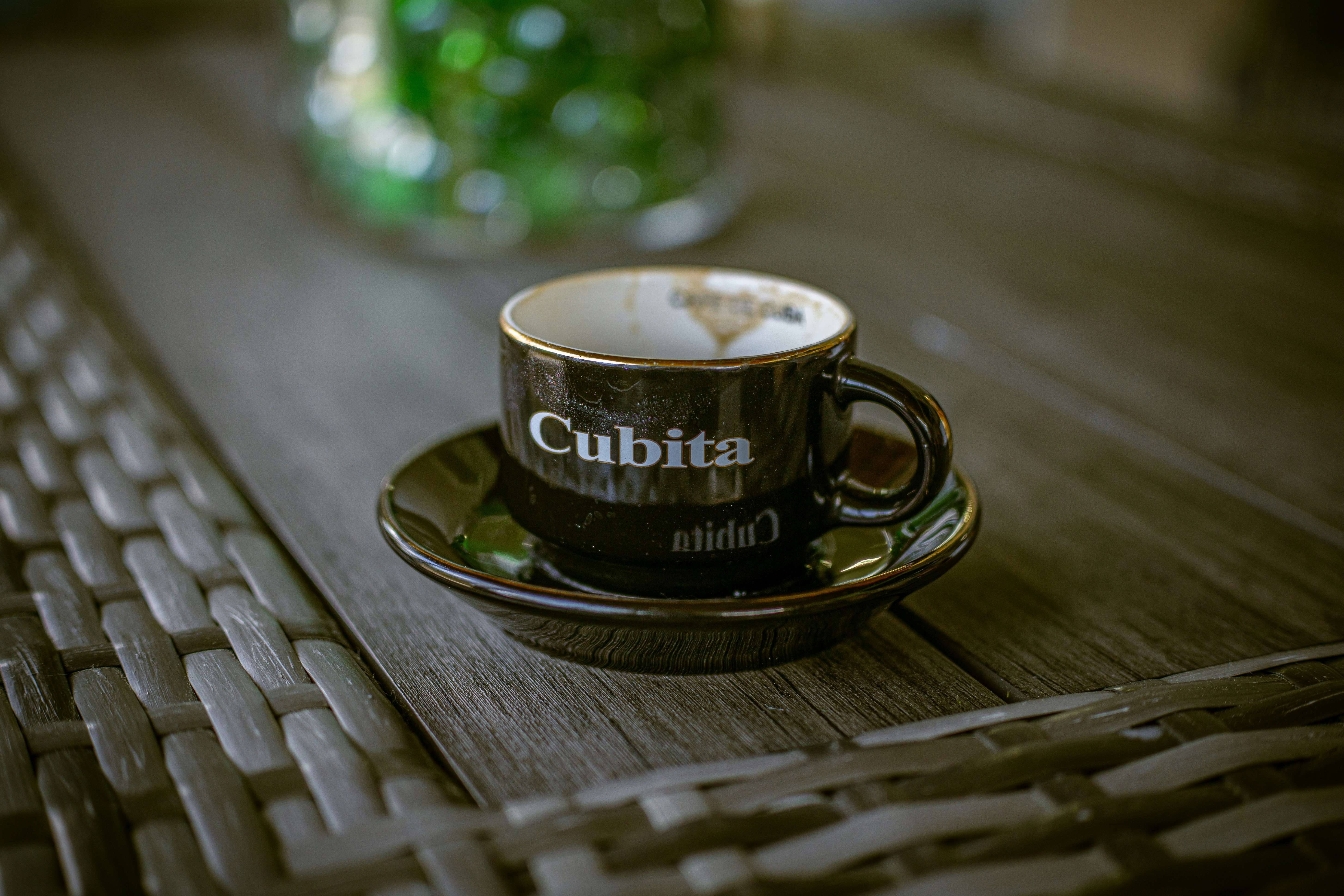 A small black cup with "cubita" written on it.
