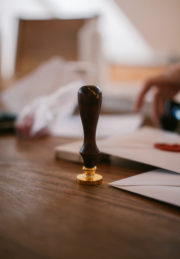 A wooden wax seal stamp on a table