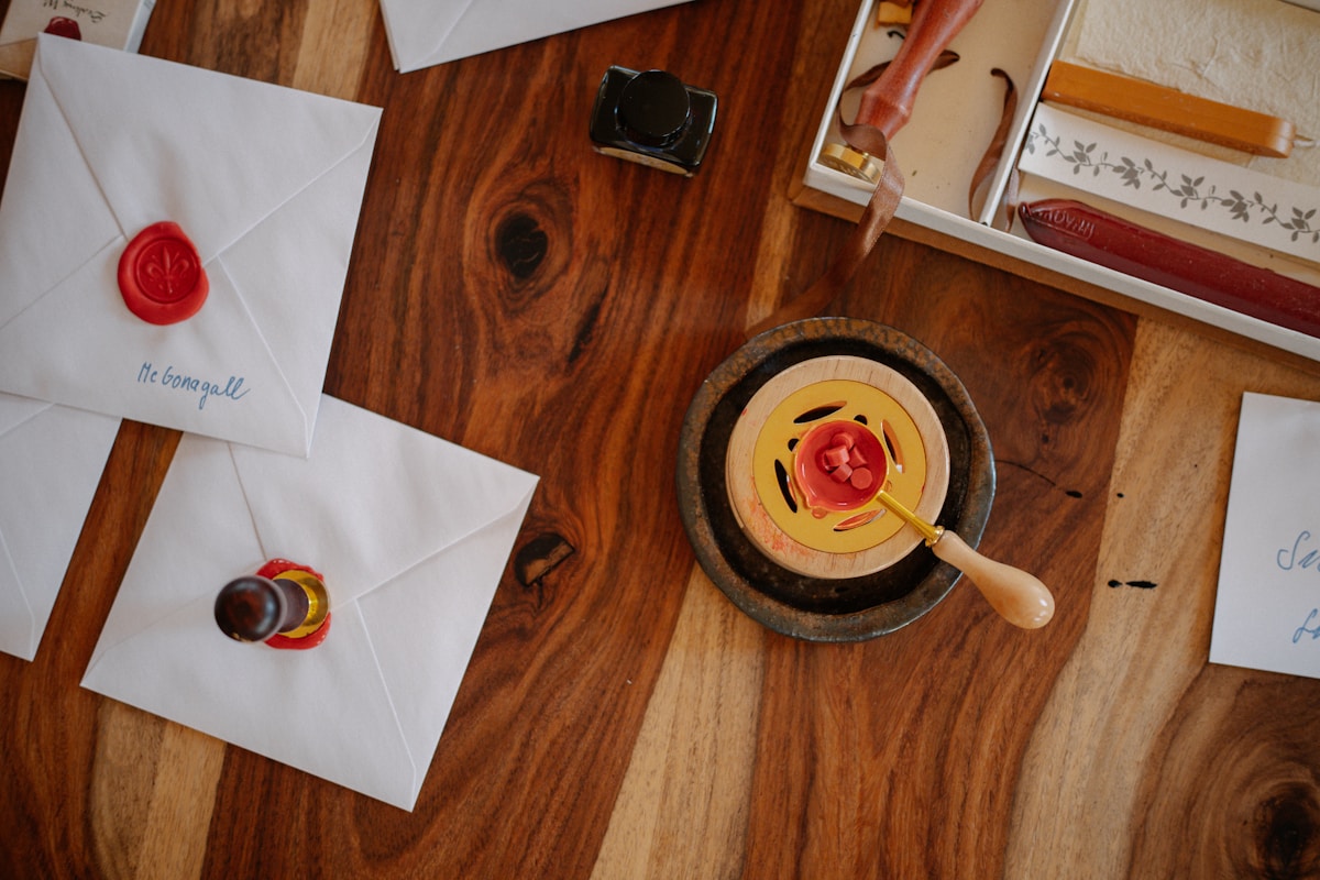 Wax-sealed envelopes on a wooden table, symbolizing thoughtful volunteer appreciation ideas for National Volunteer Week.