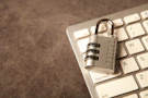 A padlock rests on a computer keyboard.