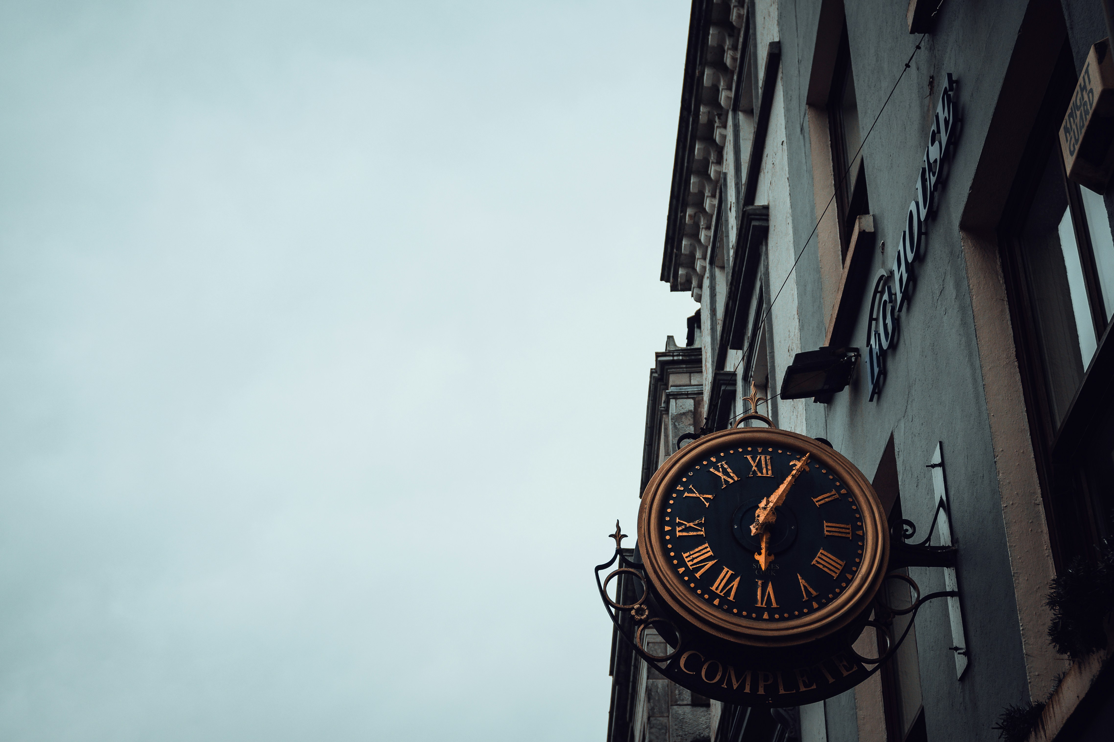 An ornate clock hangs on a building facade