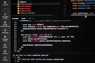 Coding on a dark theme computer screen