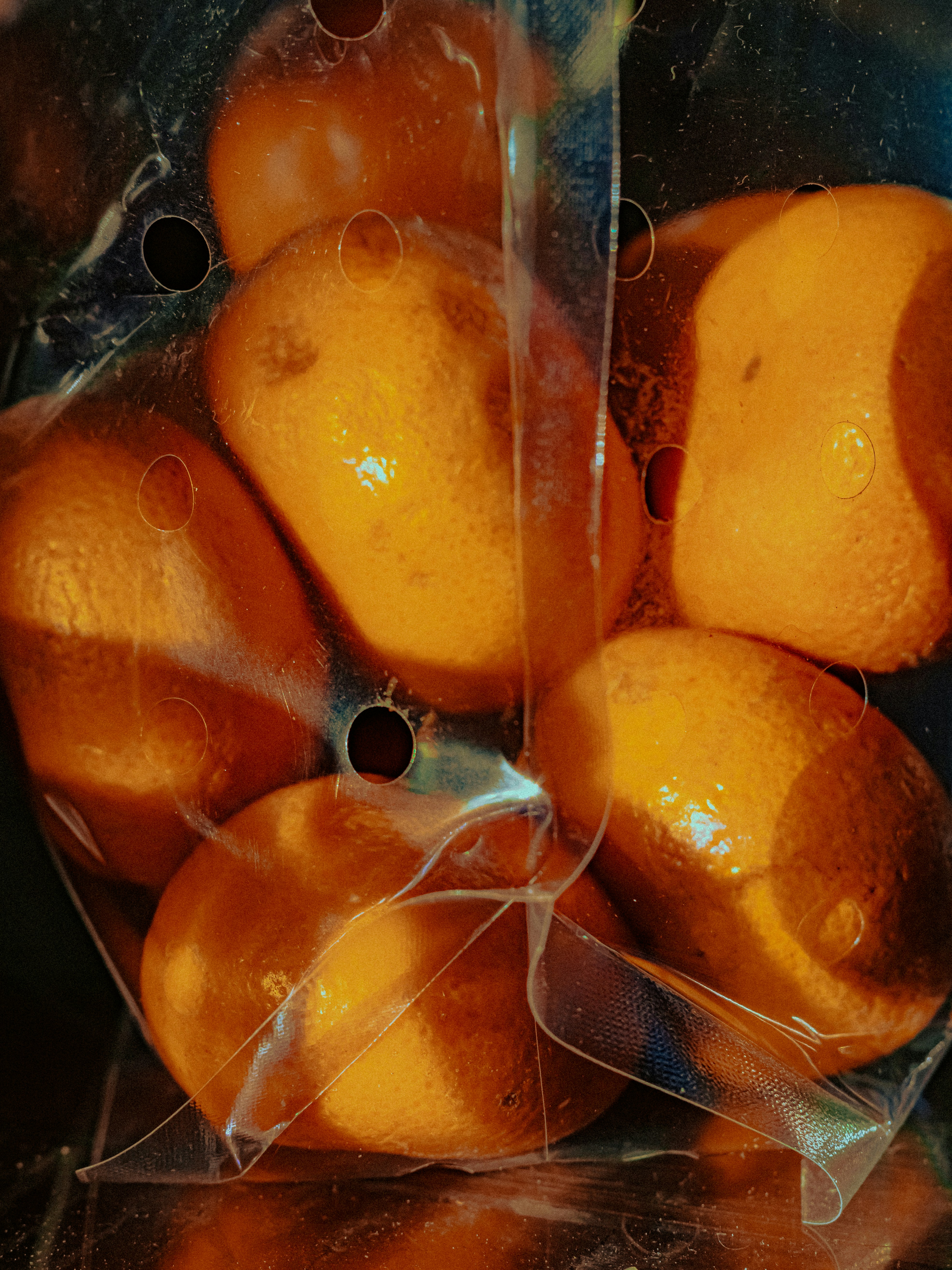 Several oranges packed in plastic packaging.