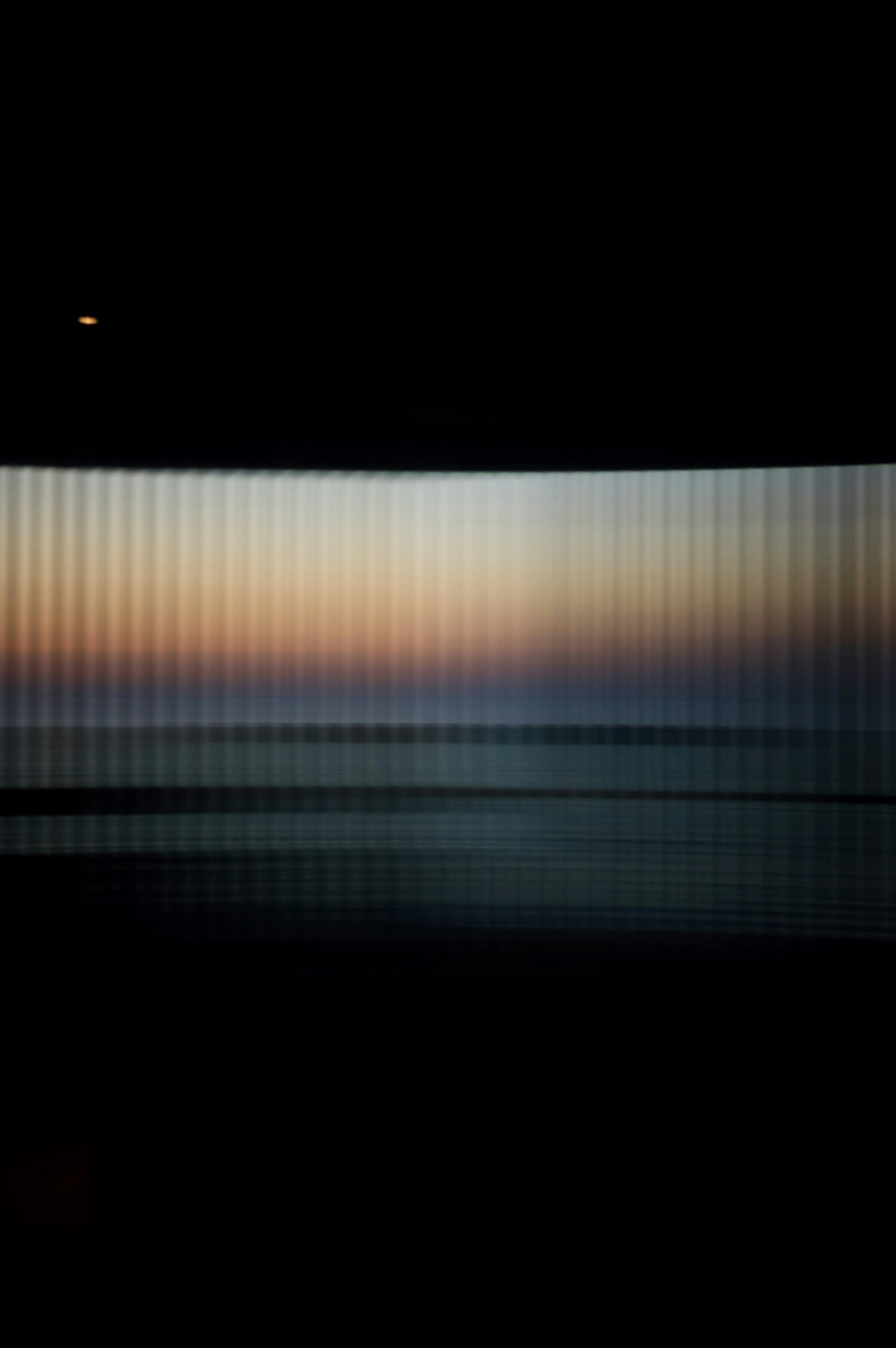 Abstract sunset over ocean with vertical lines