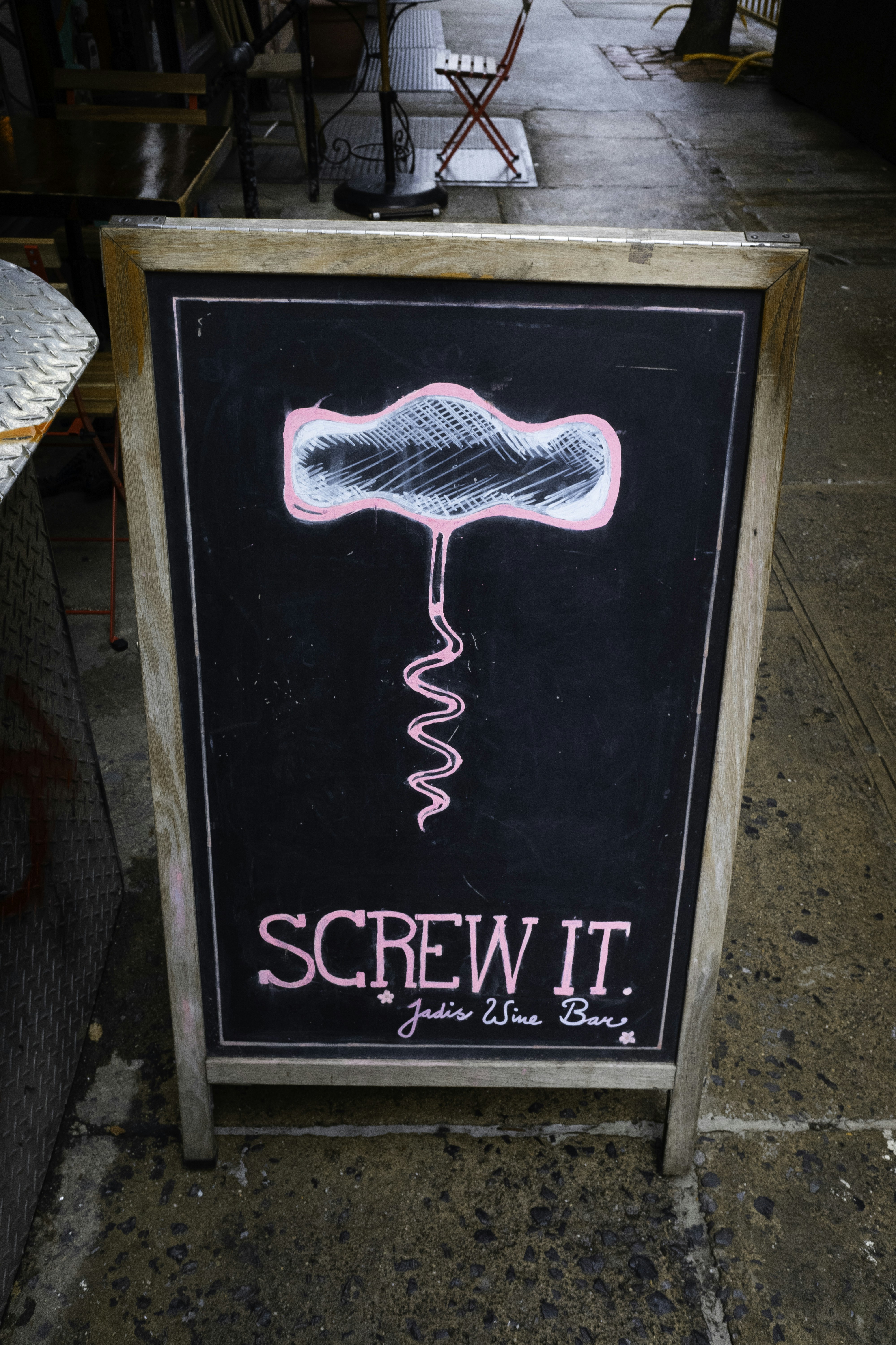 Chalkboard sign with corkscrew drawing and text