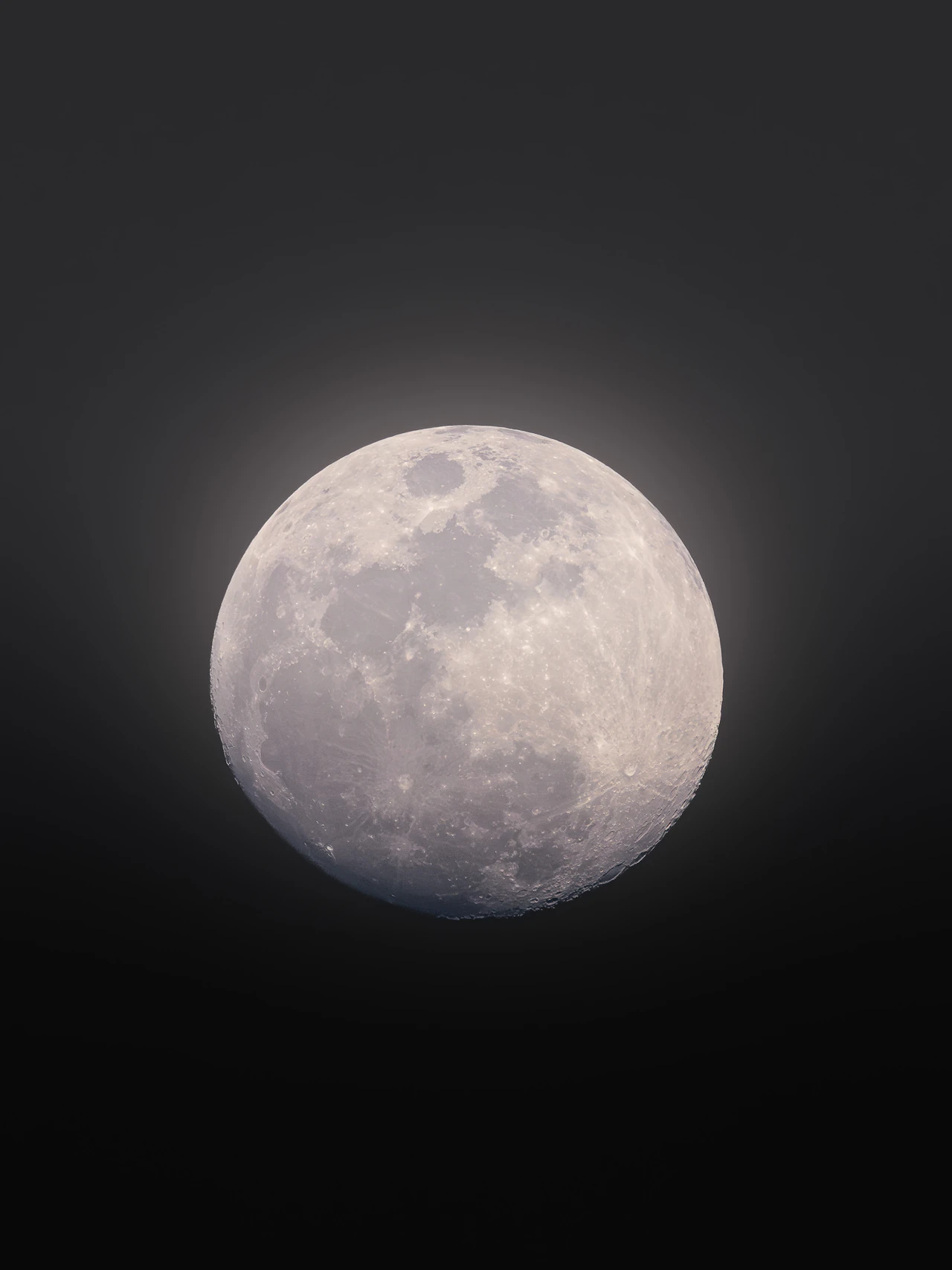 Full moon glowing in the dark night sky