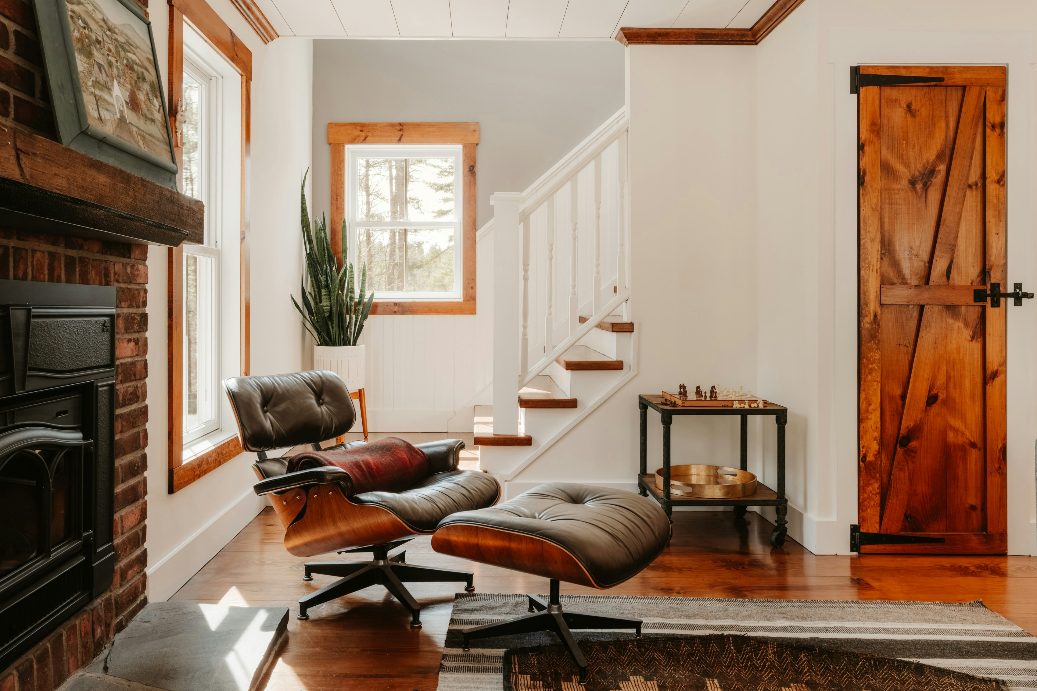 Cozy living room with eames lounge chair and fireplace.
