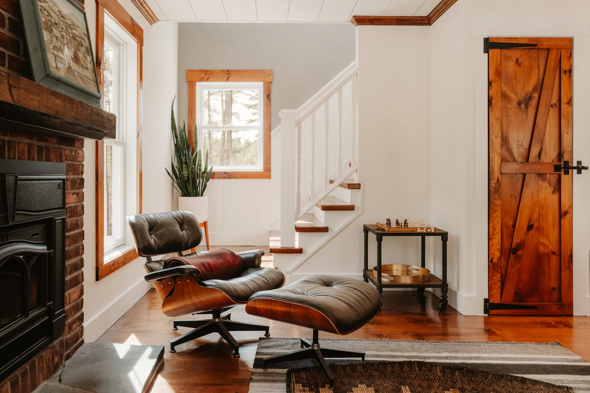 Warm contemporary living room featuring a refined lounge chair and natural architectural details
