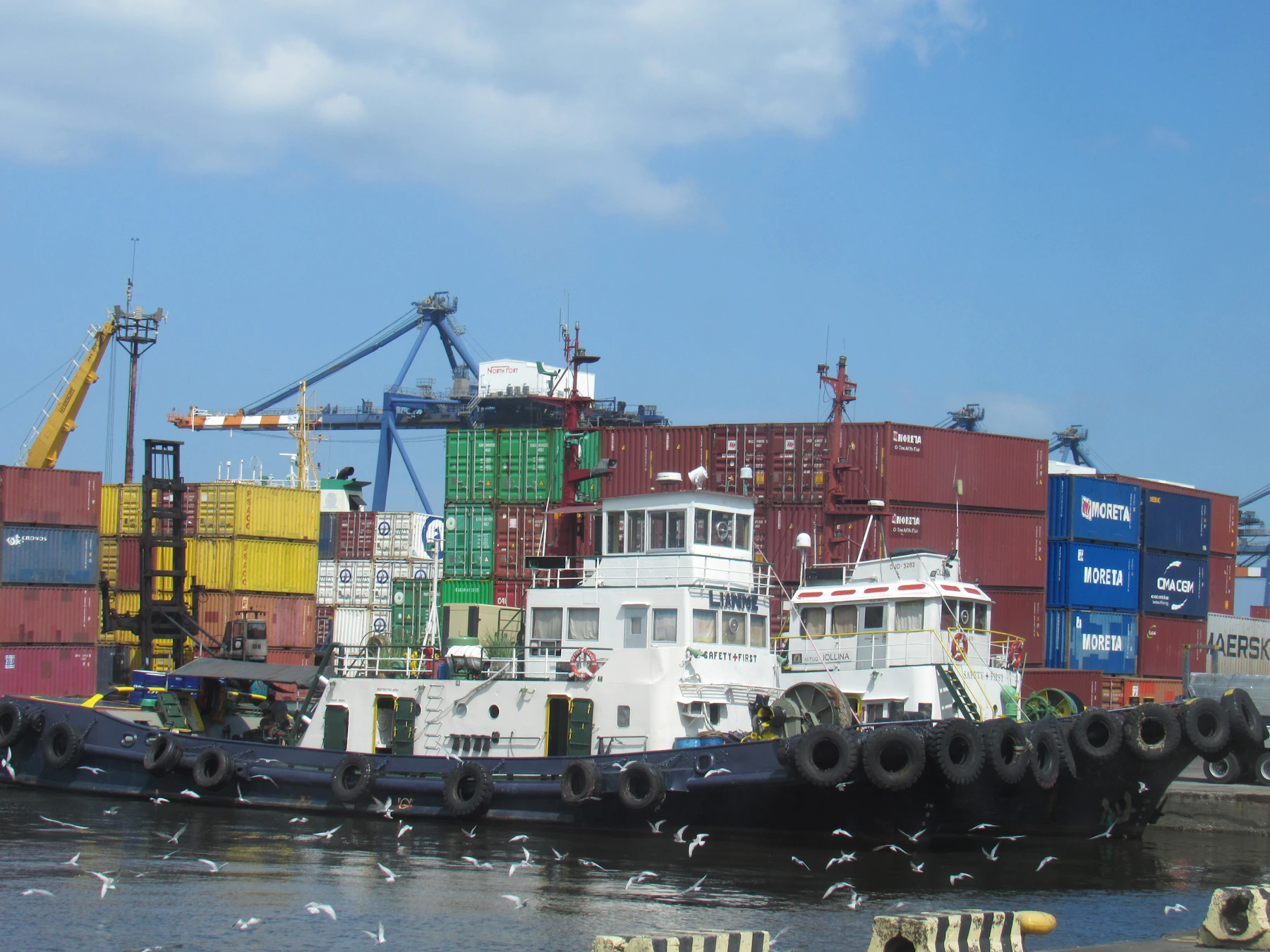 Tugboats and port operations in a busy maritime terminal