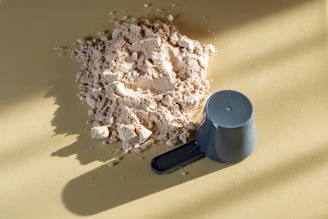 Pile of protein powder with a scoop