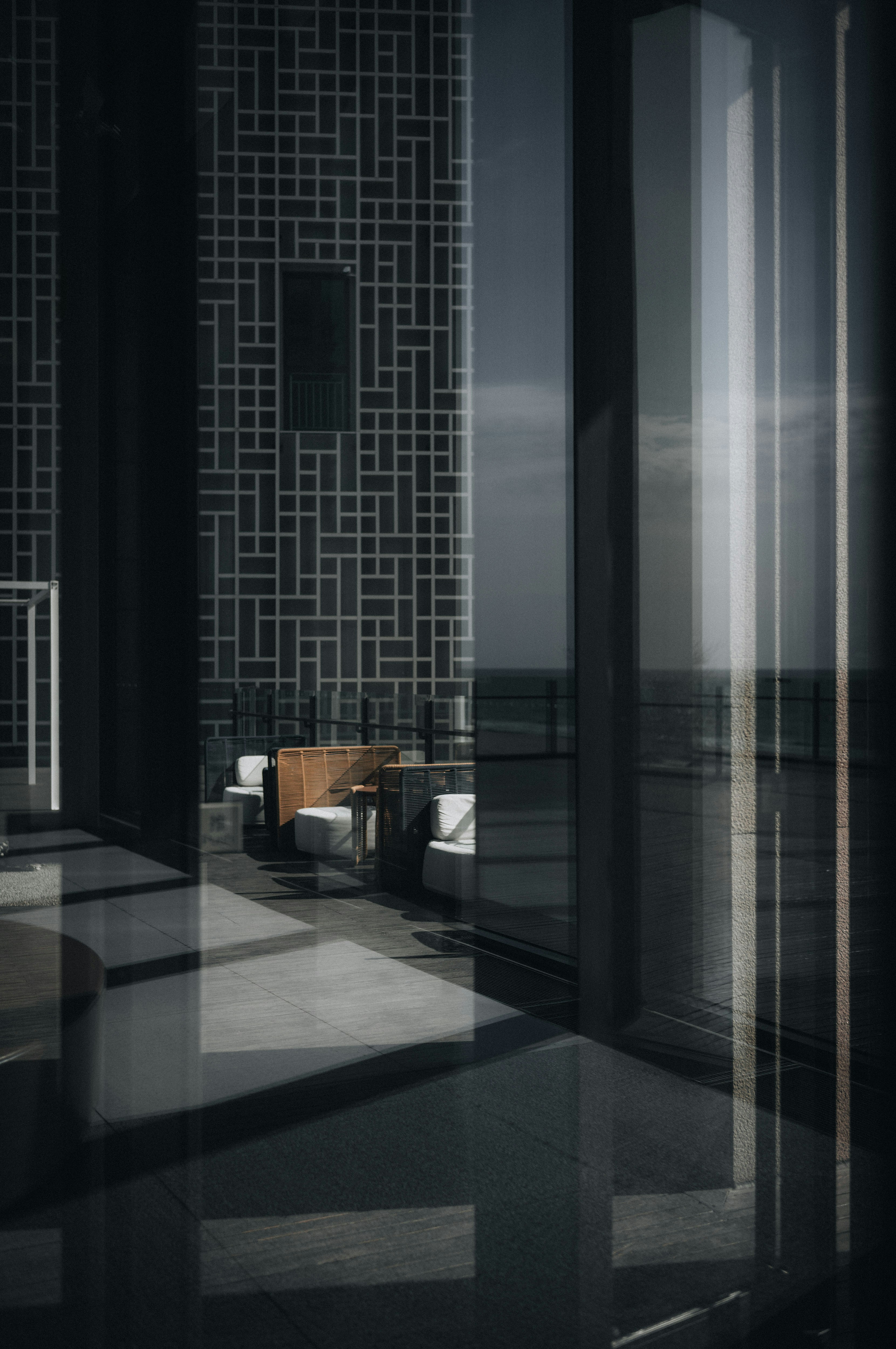 Modern lounge area with reflective surfaces and ocean view