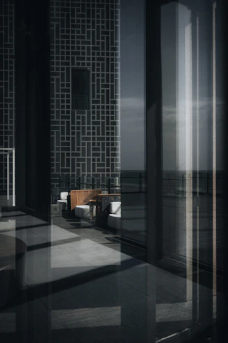 Modern lounge area with reflective surfaces and ocean view