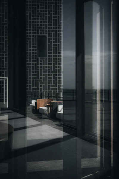 Modern lounge area with reflective surfaces and ocean view