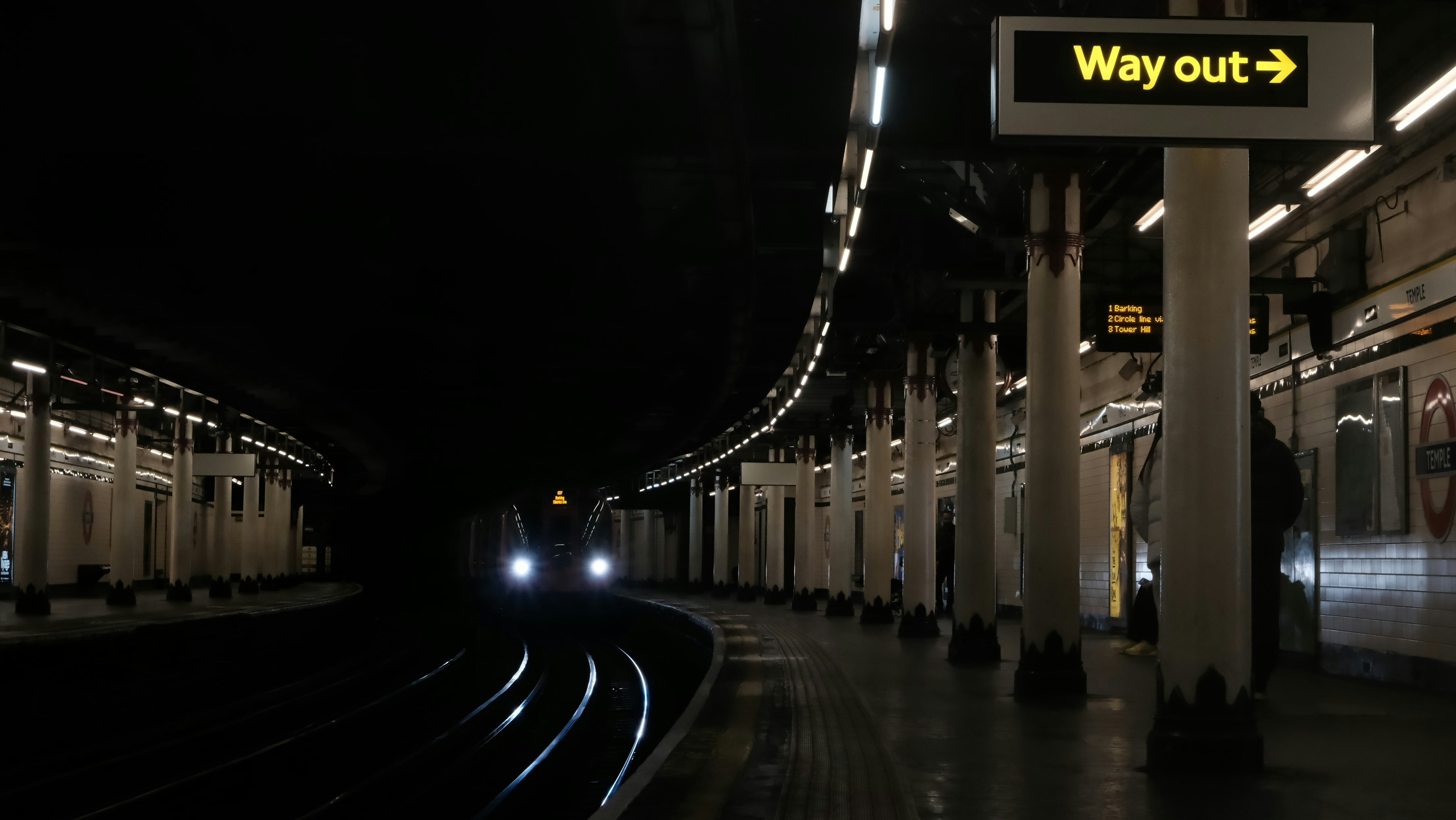 Train approaching a dark underground station