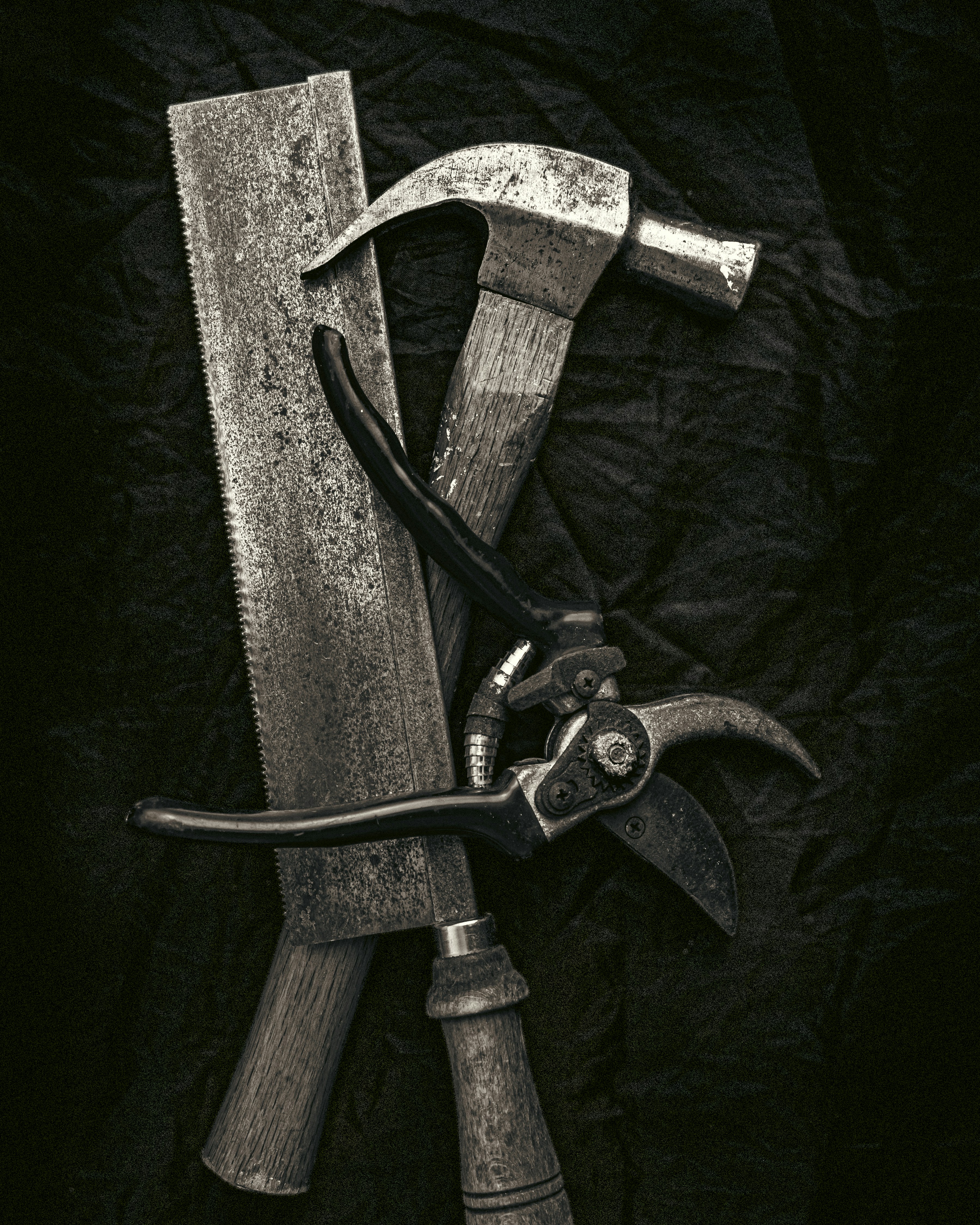 A collection of old woodworking tools on a dark background