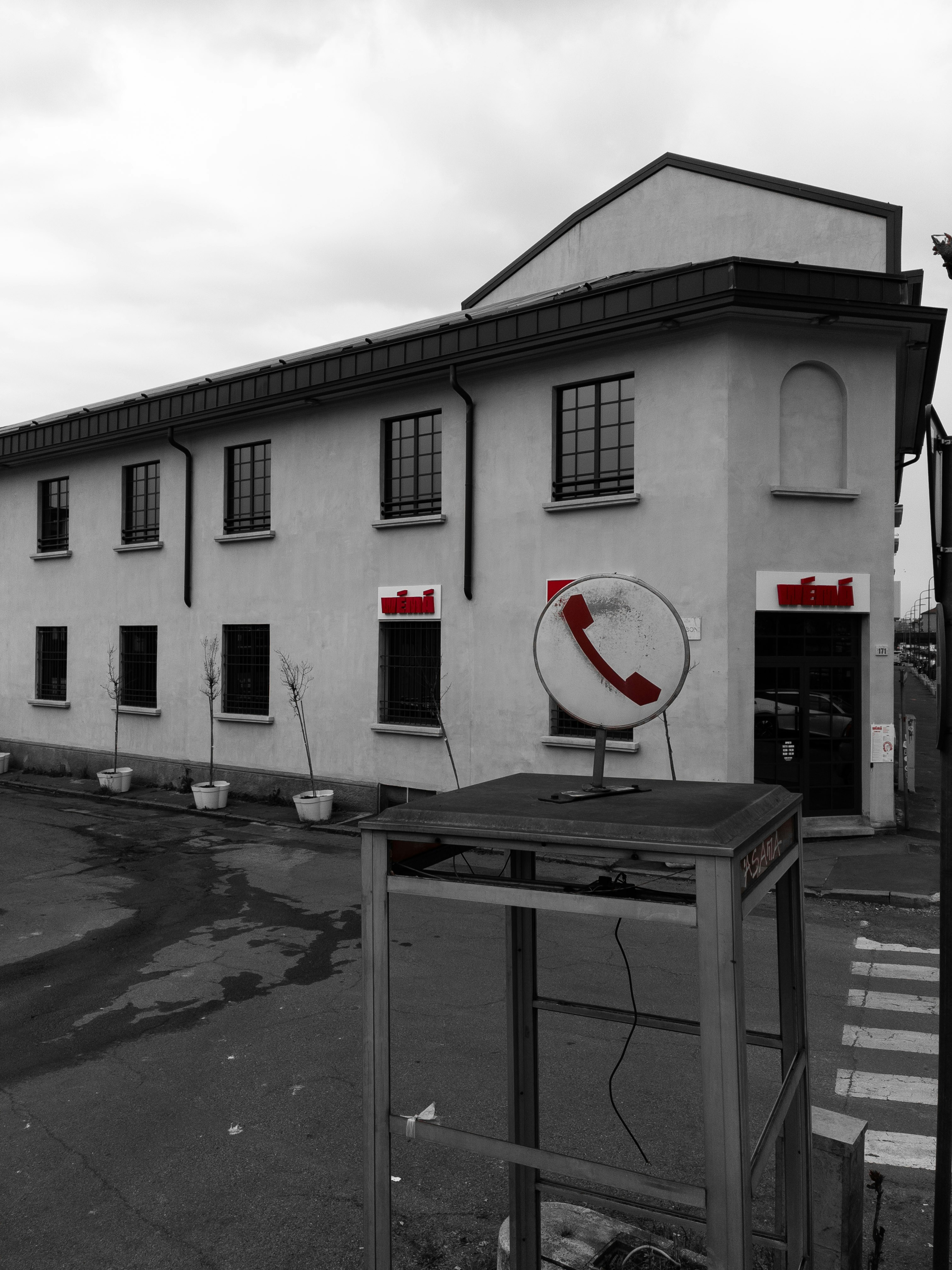 Building with red telephone sign and booth