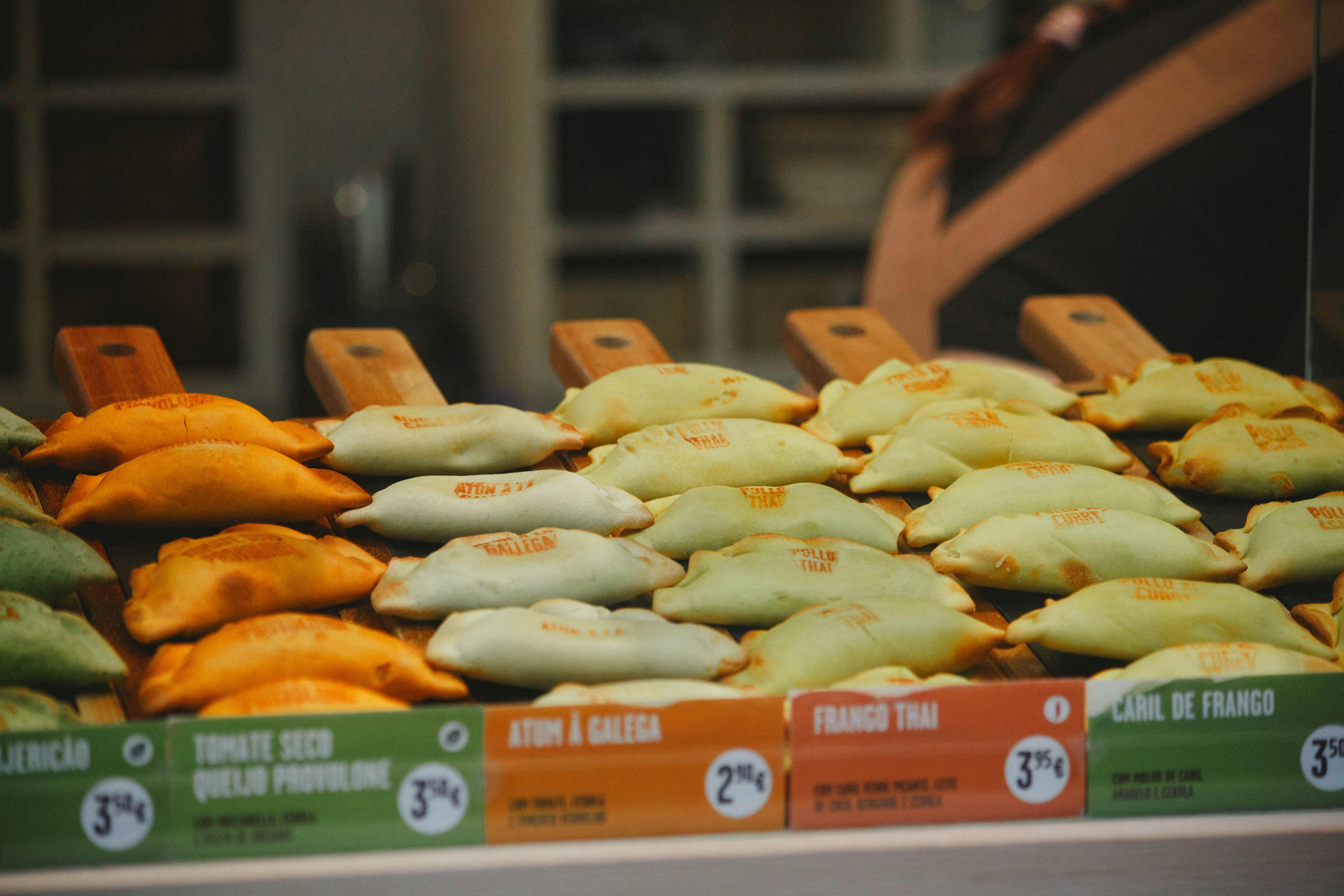 Rows of assorted empanadas on display