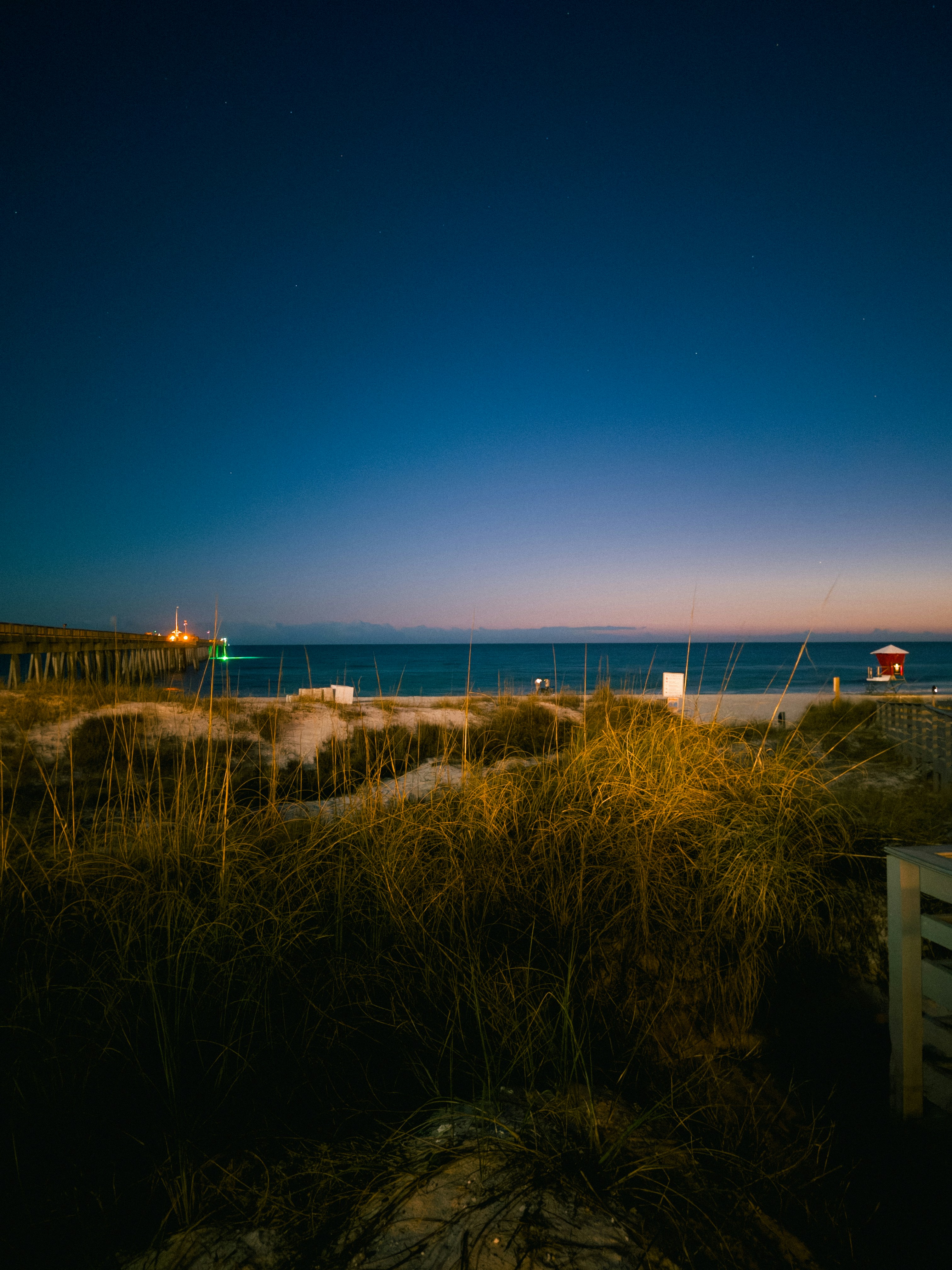 Dunes and beach at dusk with ocean in background