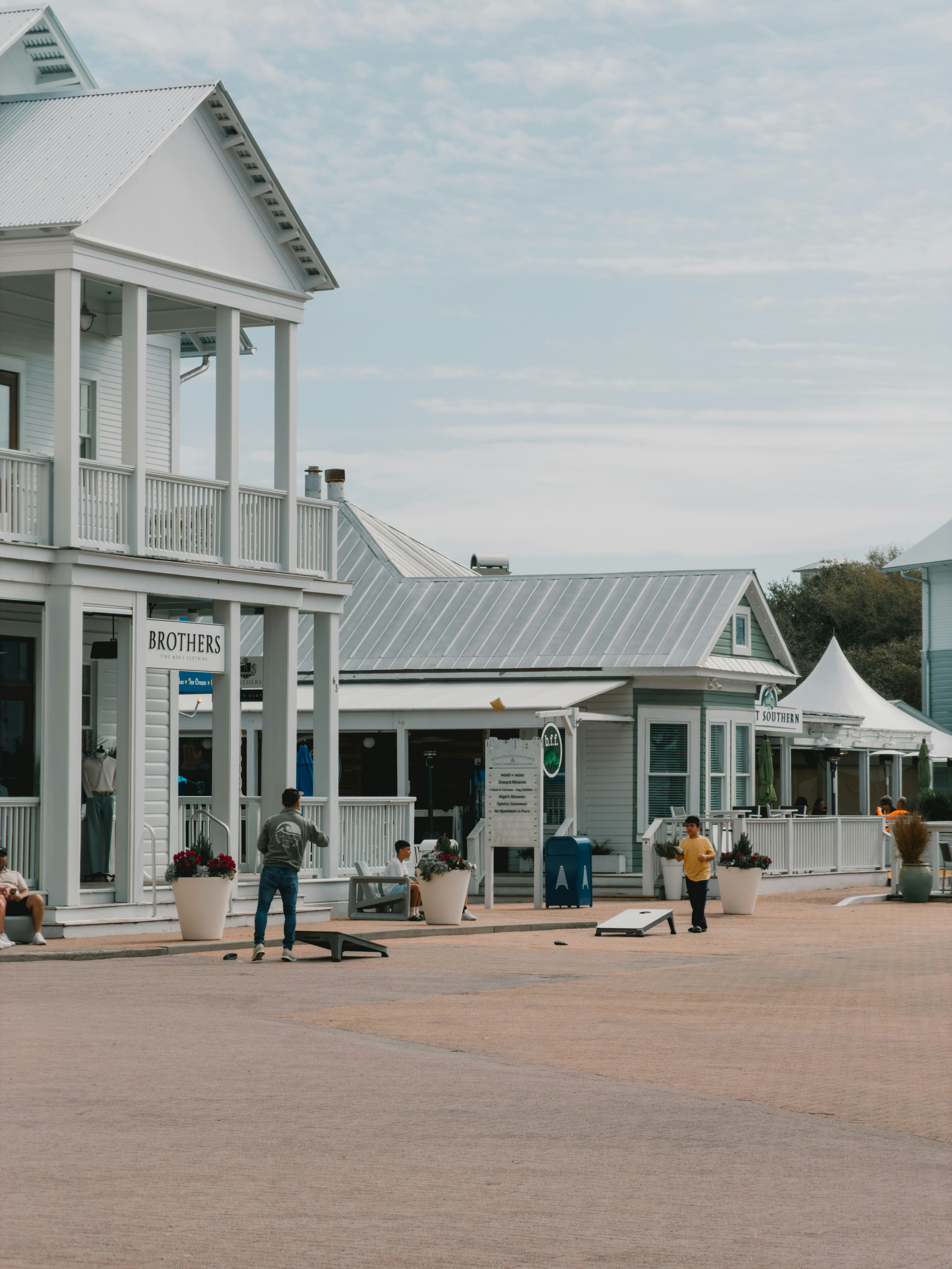 People playing cornhole in a small town square