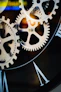 Close-up of intricate clockwork gears and roman numerals
