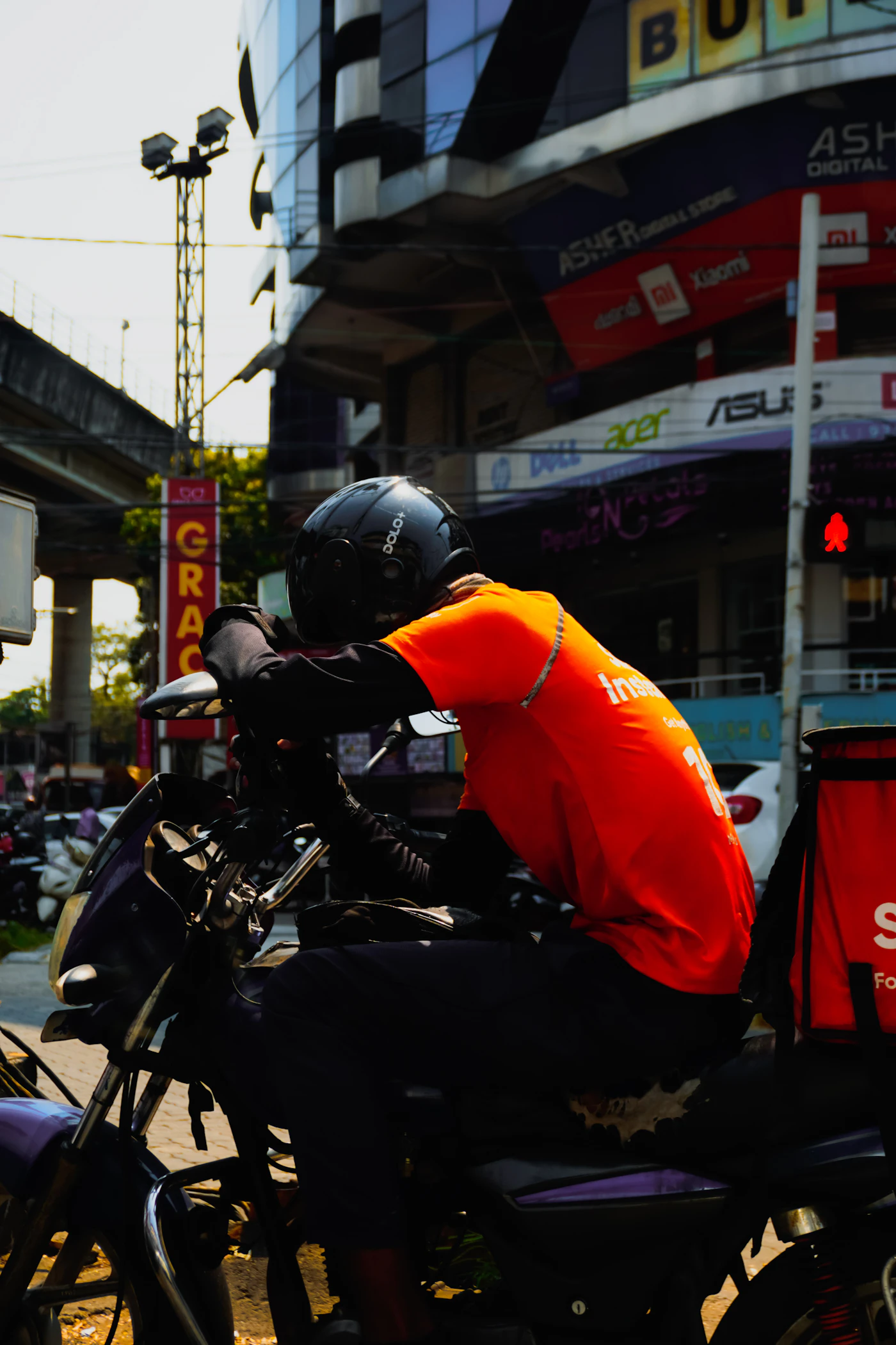 A delivery worker riding through a city street